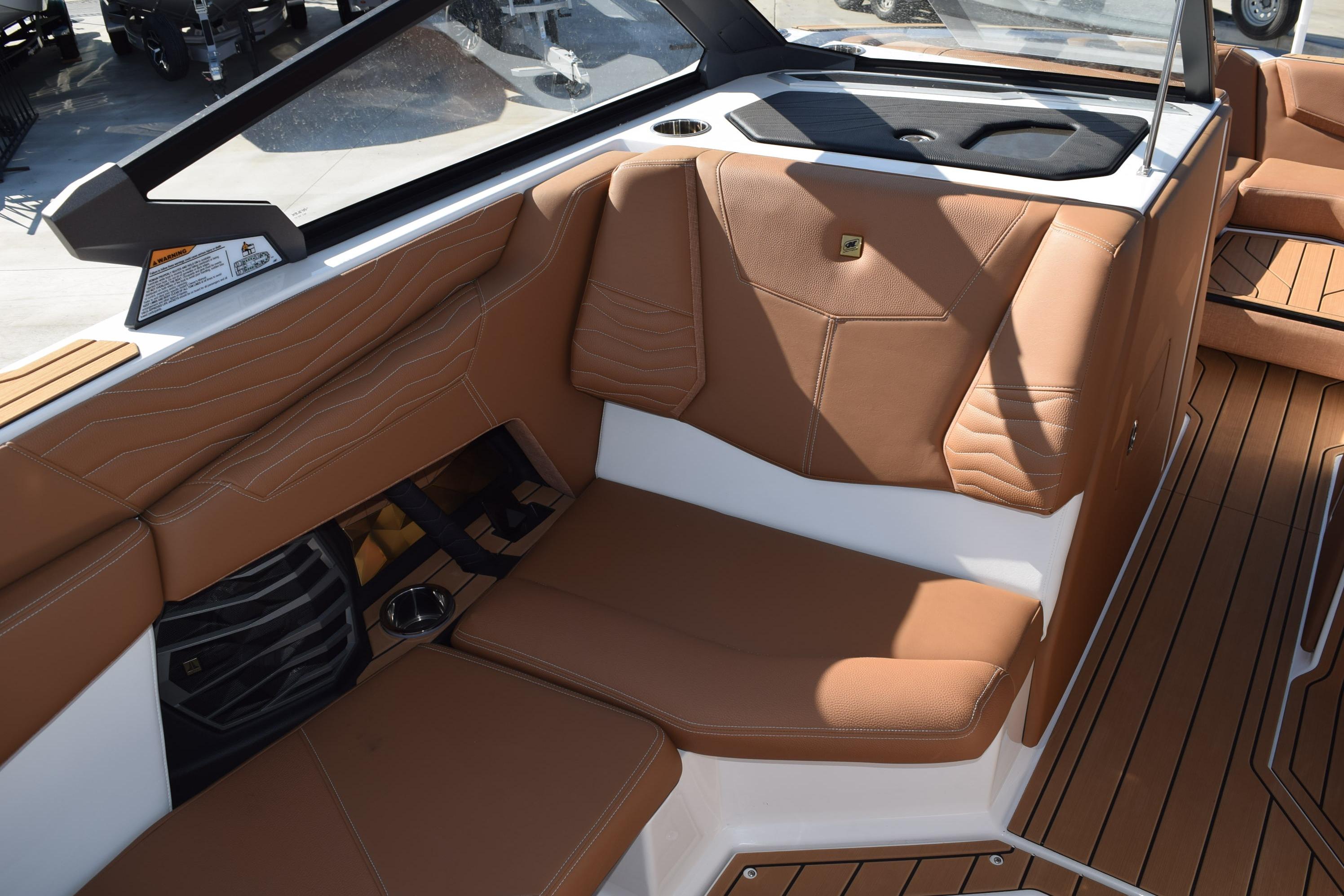 2026 Nautique Super Air Nautique G23 interior with brown leather seating and sleek design.