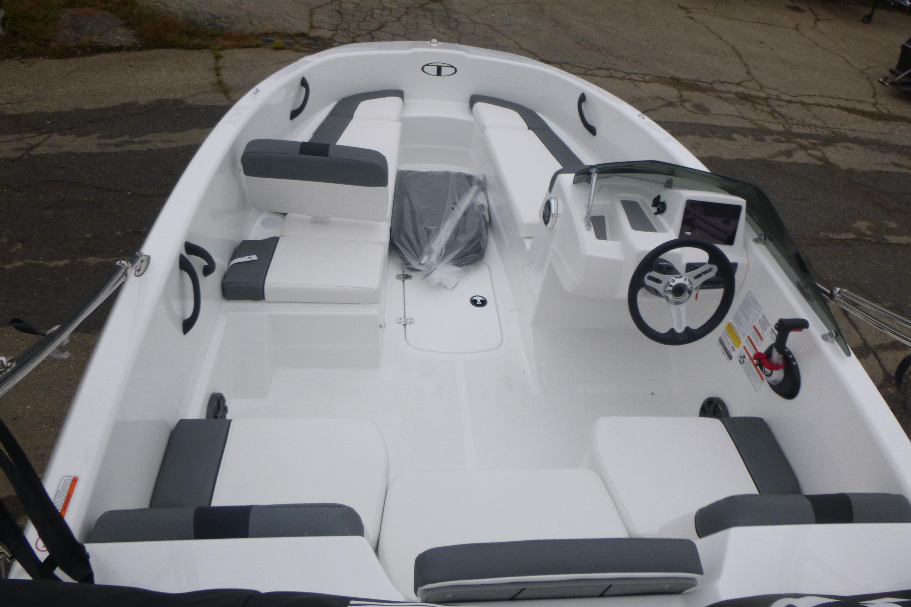2026 Tahoe T16 boat interior with white and gray seating, steering wheel, and dashboard.