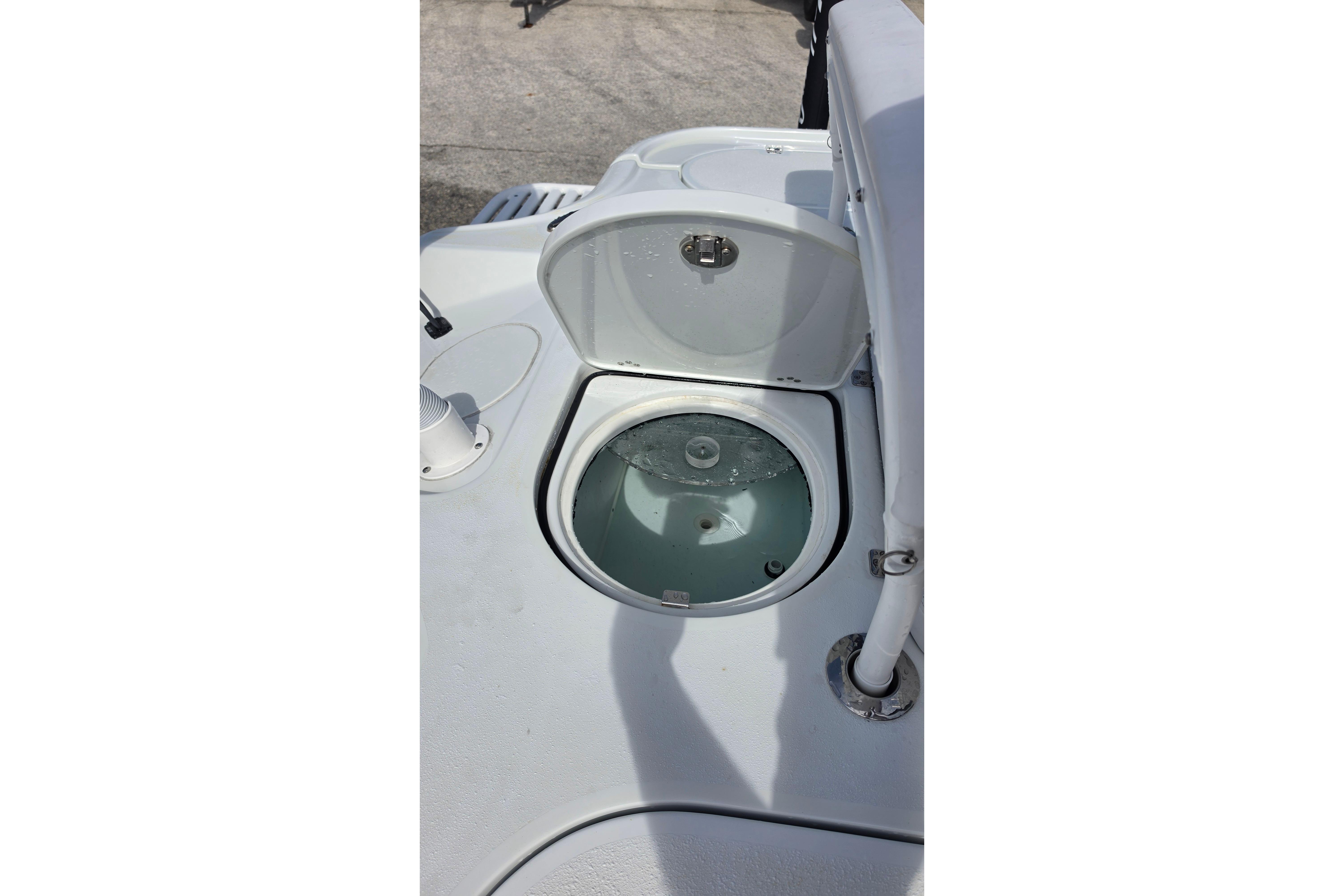Open livewell on 2026 Yellowfin 24 Bay CE boat, showcasing interior water circulation.