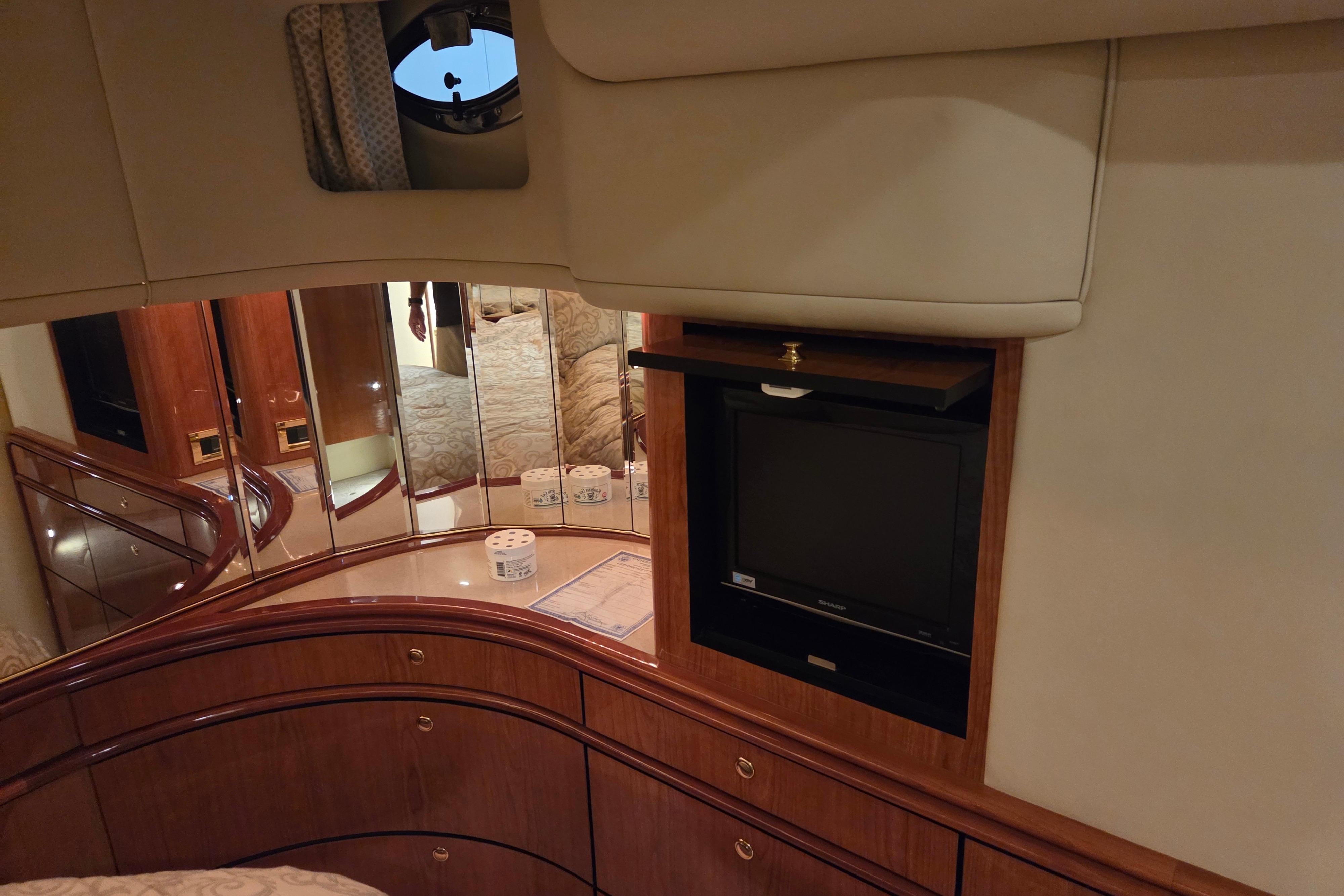 Interior of 2000 Sea Ray Sundancer 540 yacht with TV and mirrored cabinets.
