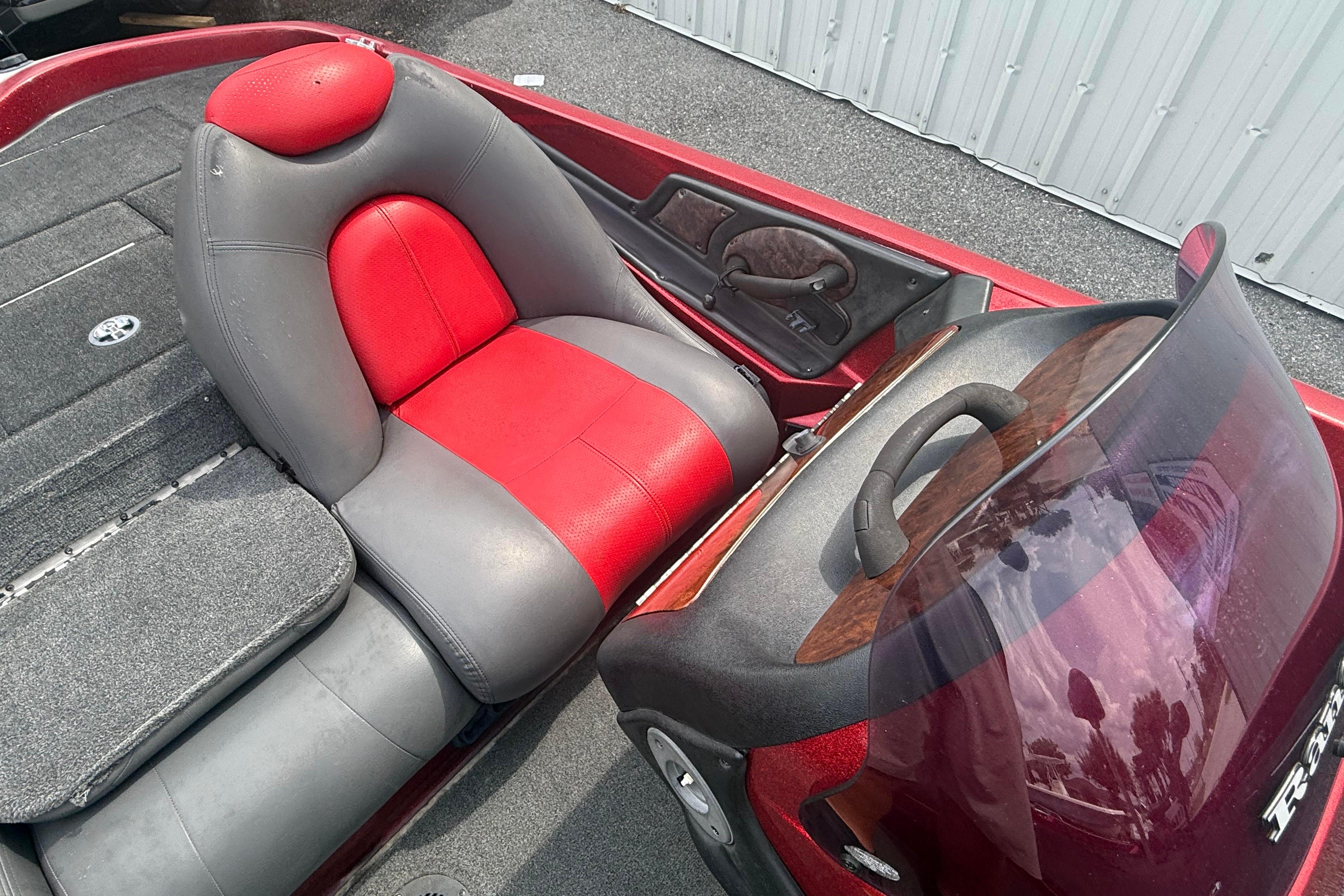 2007 Ranger 519 VX boat interior with red and gray seating, steering wheel, and windshield.