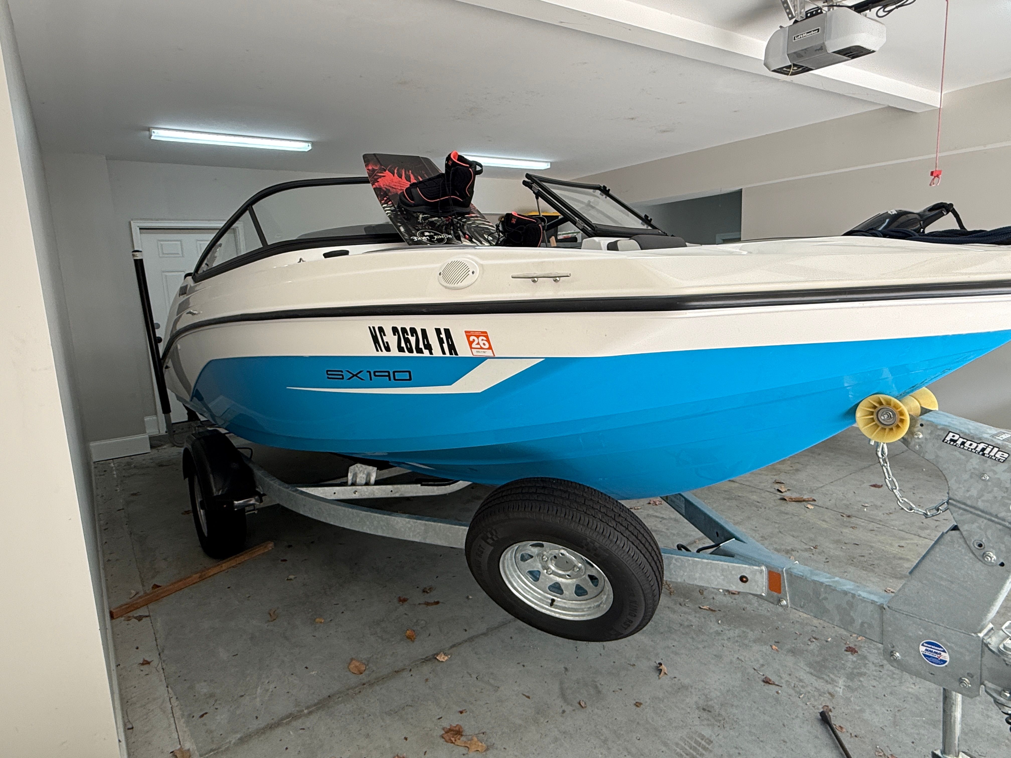 2023 Yamaha SX190 boat in garage on trailer.