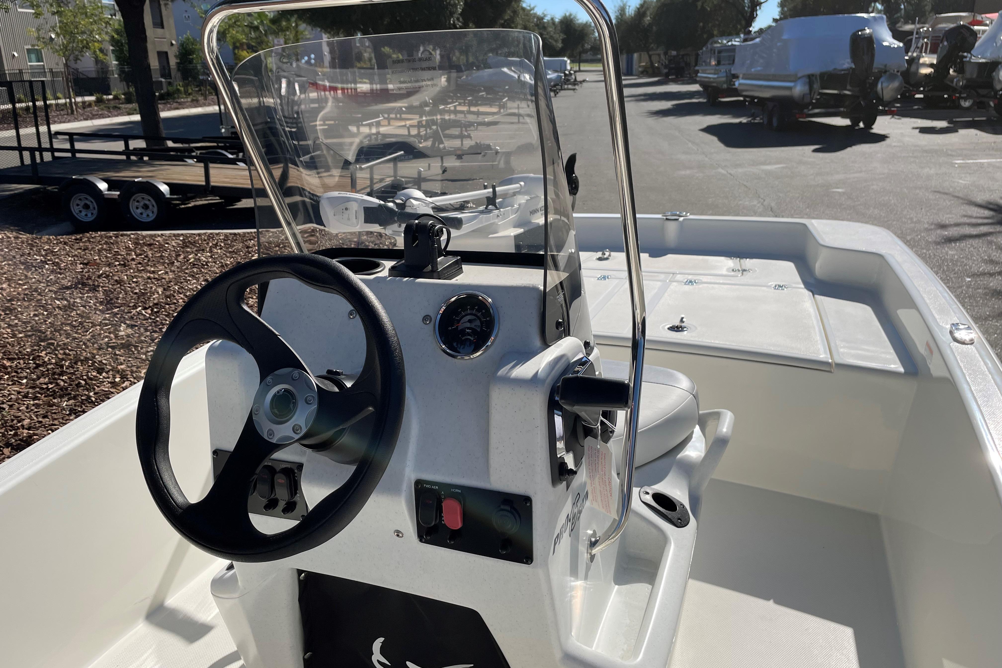 2025 Mako Pro Skiff 15 CC boat interior with steering console and seating.