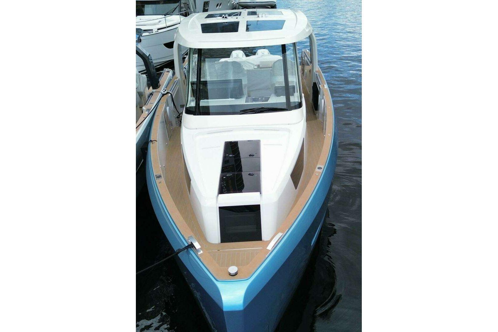 2024 Fjord 41XP boat with sleek design, docked on calm water.