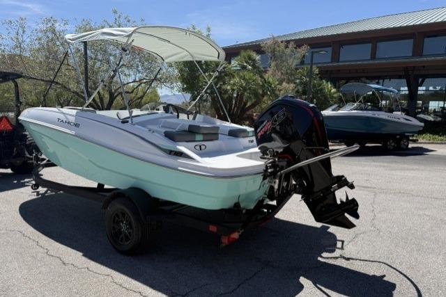 2026 Tahoe T18 boat with canopy on trailer, parked outdoors.