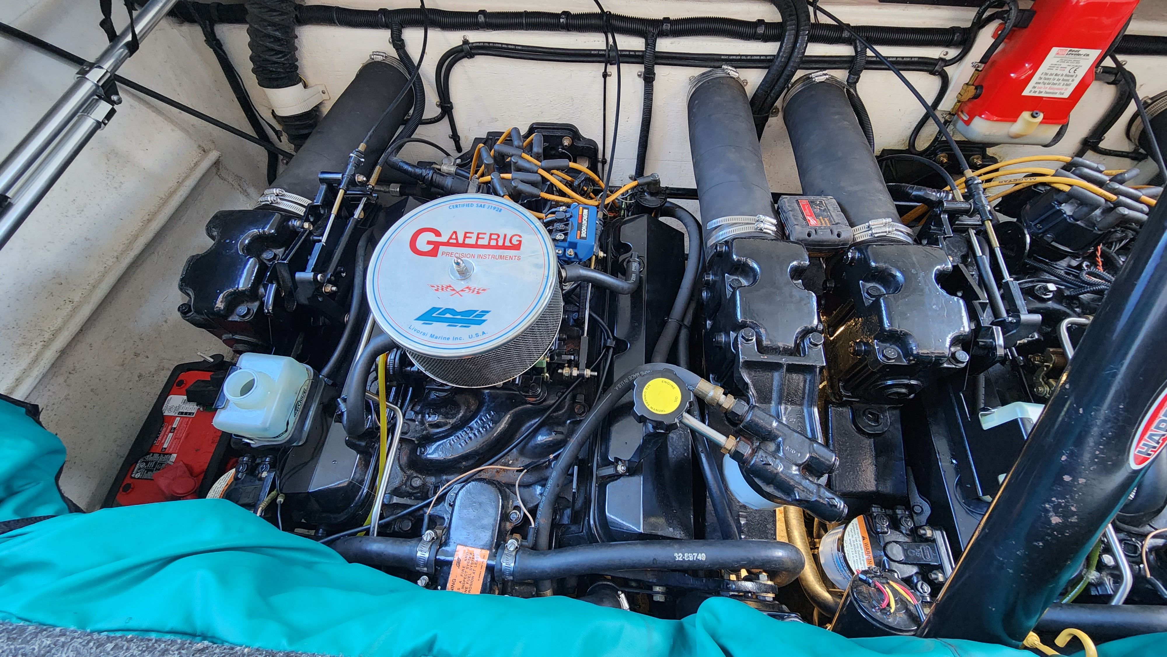 Engine compartment of a 1998 Powerquest Enticer 290 FX with dual engines and wiring.