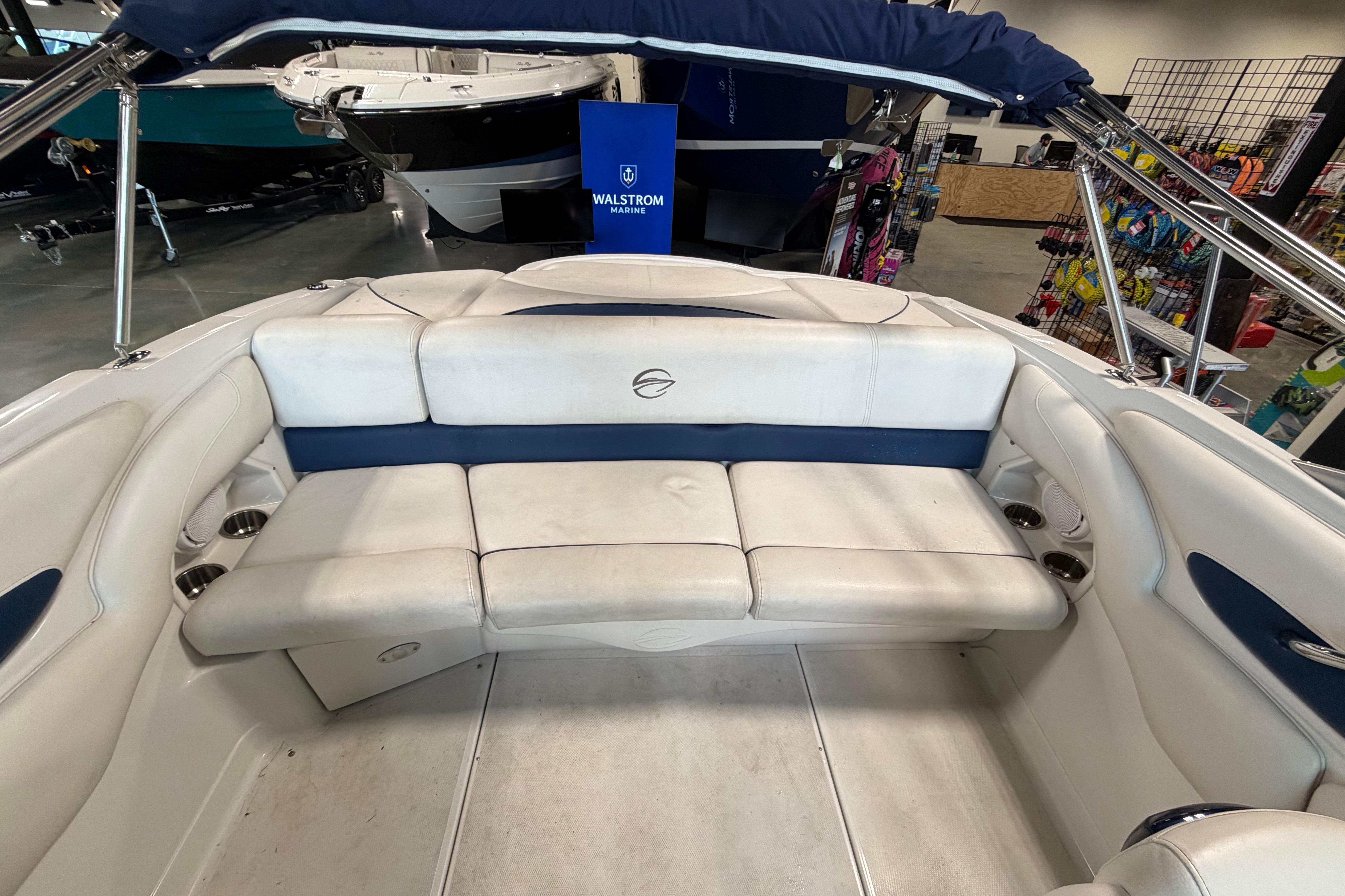 2008 Crownline 220 LS boat interior with white and blue seating in showroom.