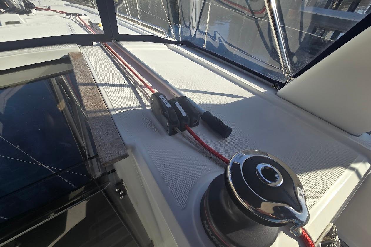 2023 Beneteau Oceanis 38.1 yacht deck with winch and red rope.
