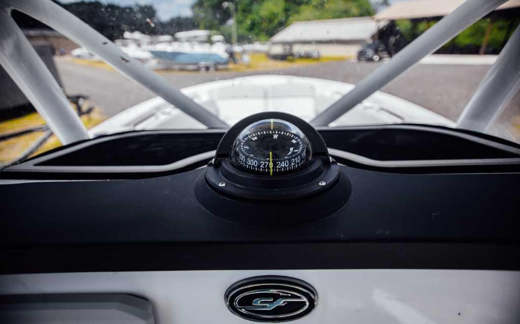Compass on 2021 Sea Fox 248 Commander boat dashboard, with outdoor marina background.