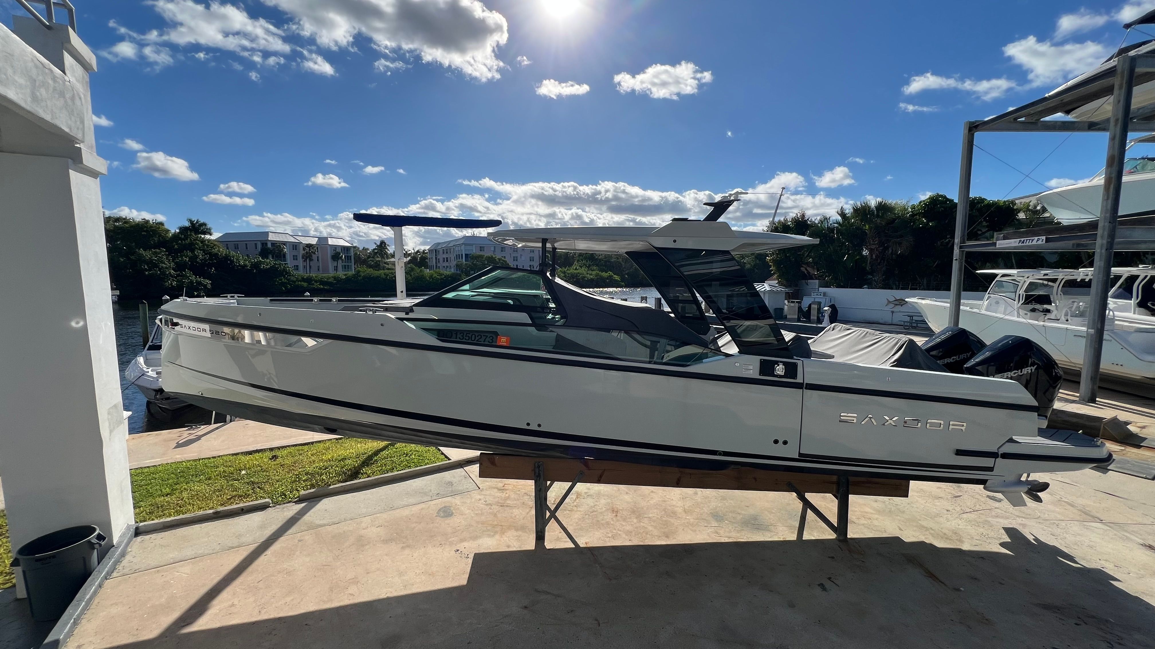 2024 Saxdor 320 GTO boat docked under sunny skies.