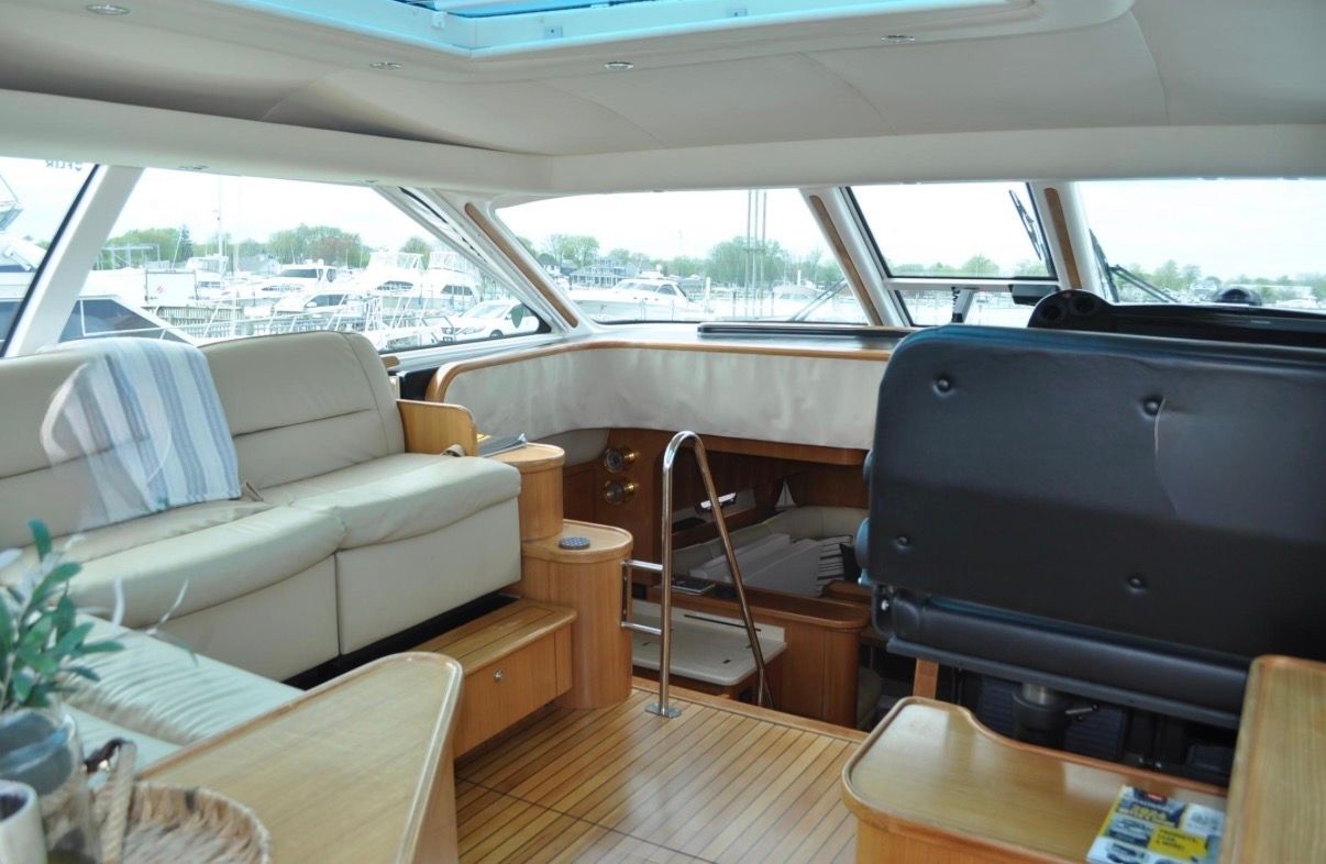 Interior of a 2005 Tiara Yachts 5200 Sovran with leather seating and wooden flooring.