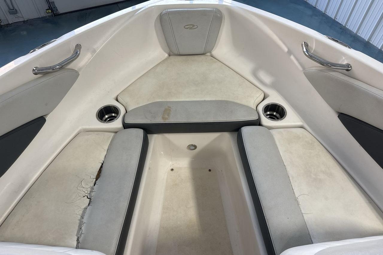 Interior of 2012 Regal 1900 Bowrider boat with seating and cup holders.