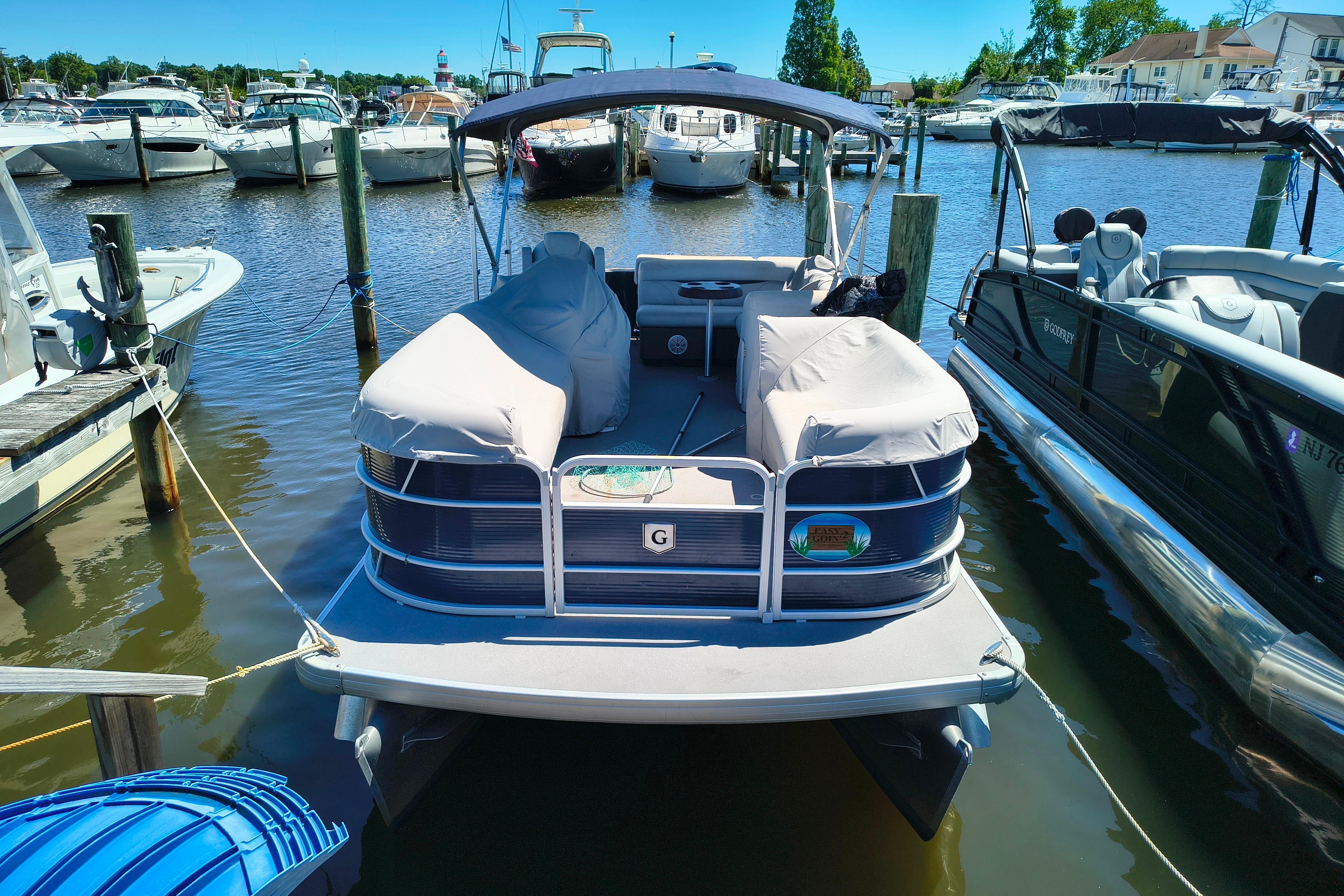 2018 Godfrey Sweetwater 2286 C pontoon boat docked in a marina.