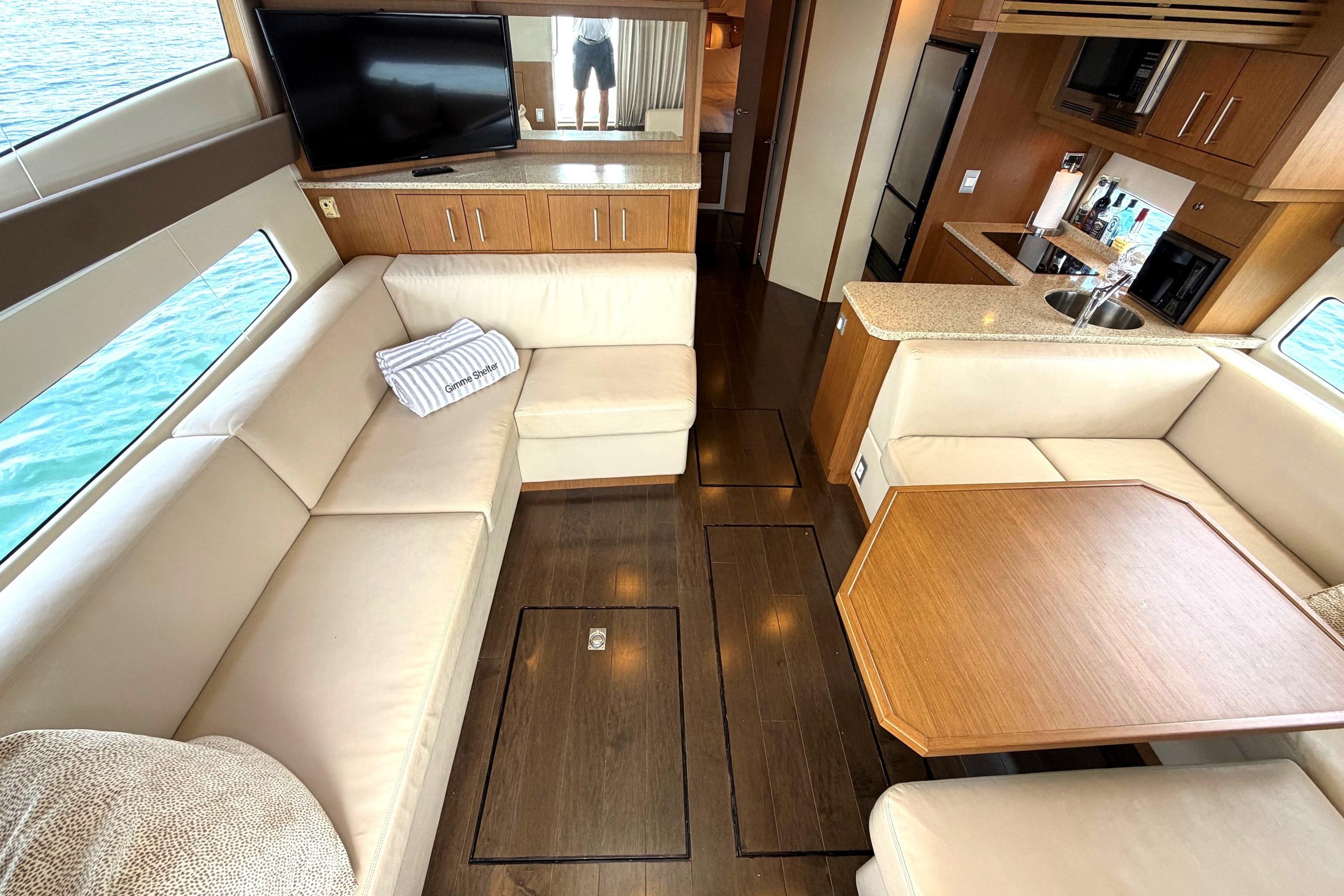 Luxurious interior of 2011 Carver 44 Sojourn yacht with elegant seating and modern amenities.