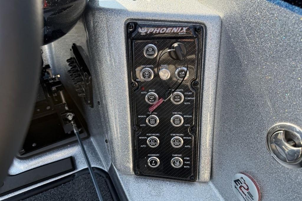 Control panel of 2026 Phoenix 20 XE boat with various switches and dials.