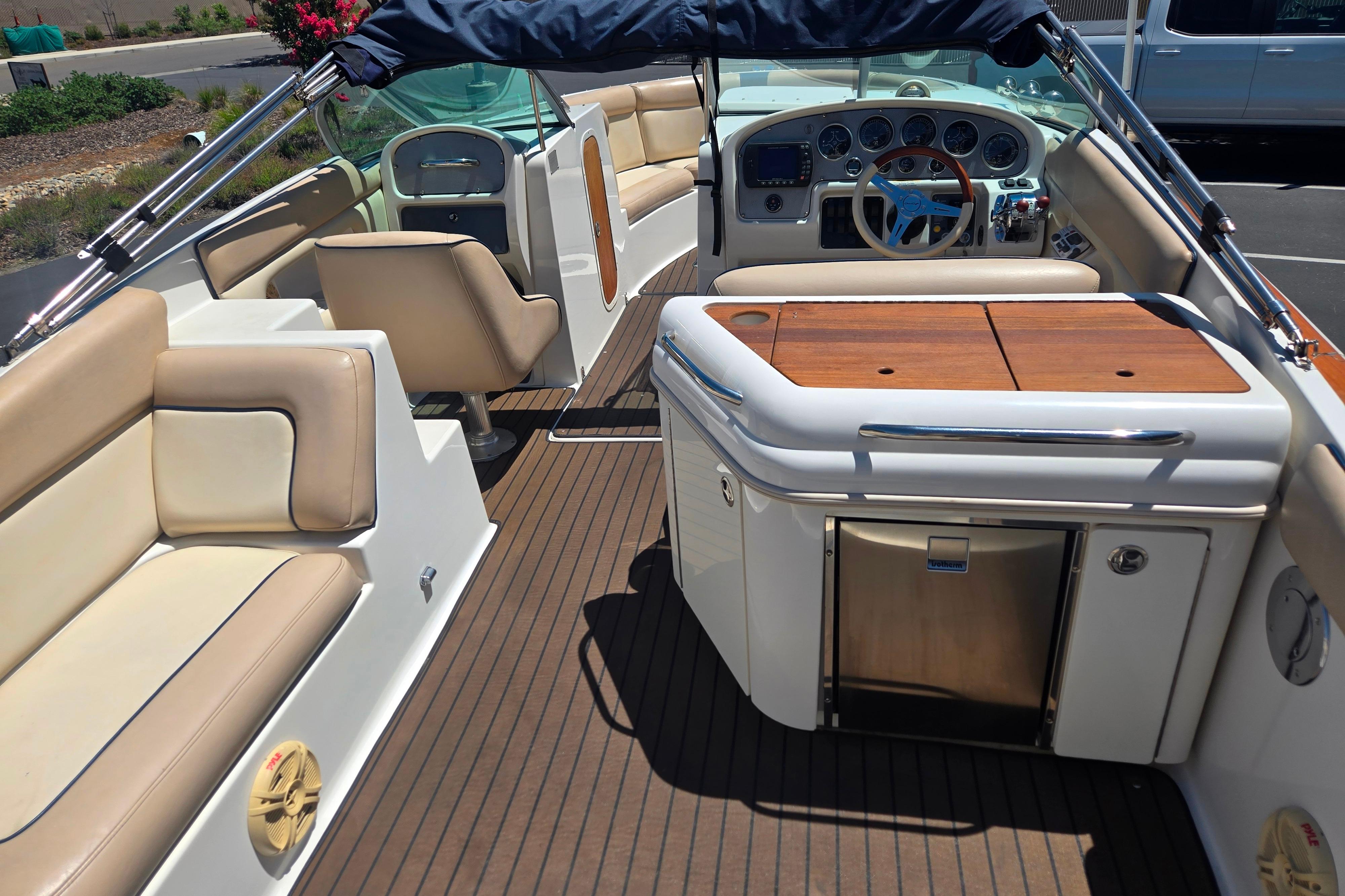 Luxurious interior of a 2002 Chris-Craft Launch 28 GT I/O boat with elegant seating and dashboard.