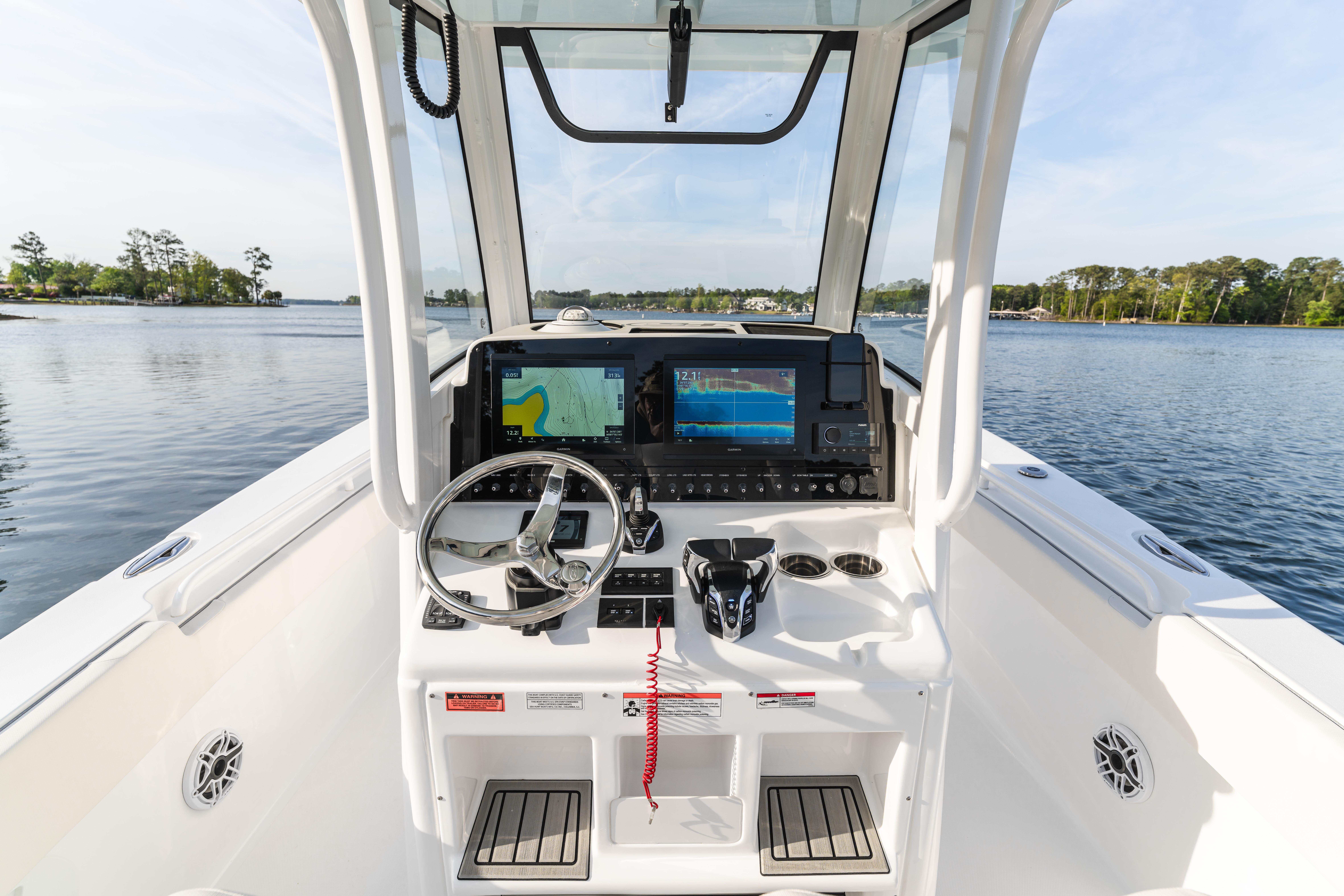 2027 Sea Hunt Ultra 275 SE boat dashboard with navigation screens on a calm lake.