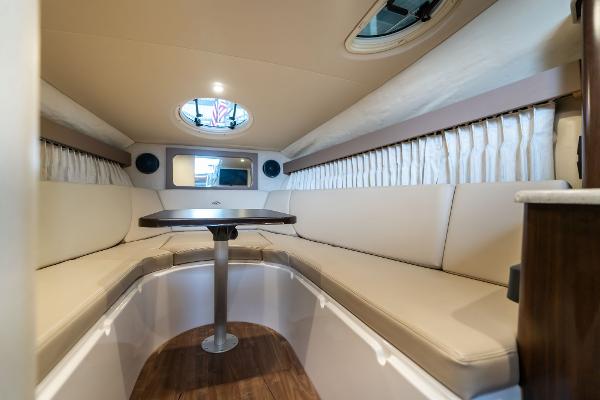 Interior of a 2016 Regal 28 Express boat with beige seating and a central table.