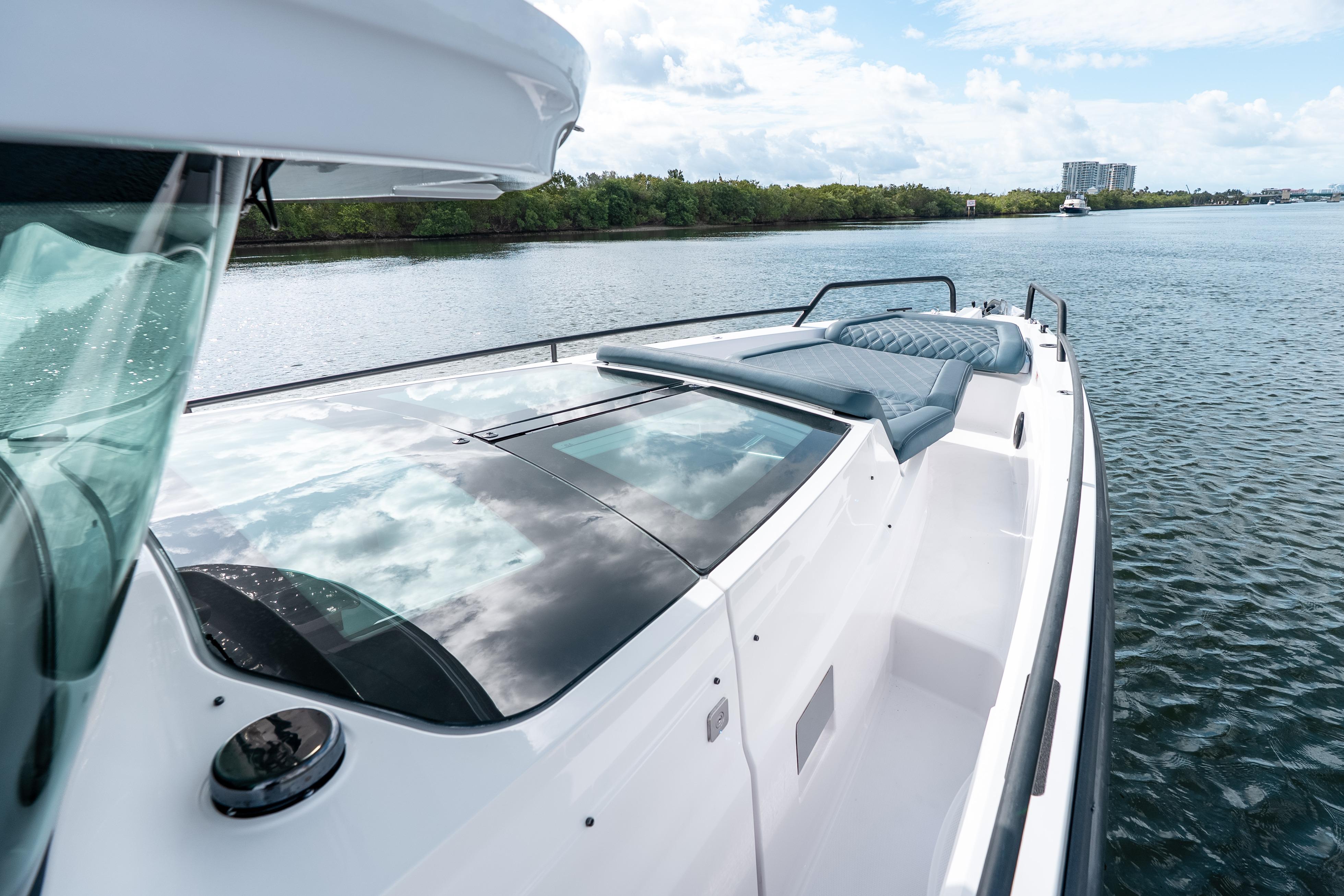 2022 Axopar 37 XC Cross Cabin boat on calm water, featuring sleek design and spacious deck.