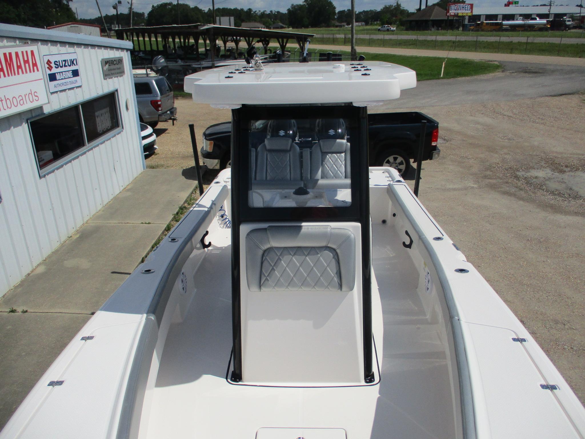 2024 Blue Wave 2800 Makaira boat at dealership, showcasing sleek design and spacious interior.