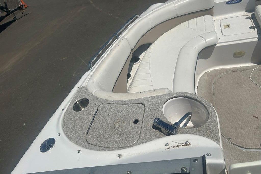 2006 Four Winns 244 Funship boat interior with white seating and cup holders.