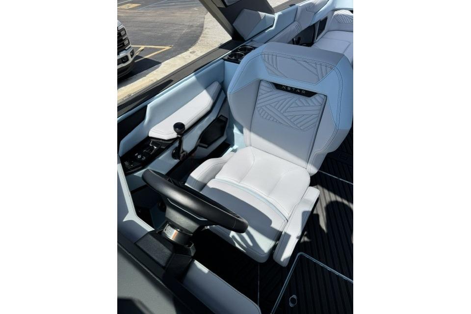 Interior of 2026 MasterCraft XStar 25 boat, featuring sleek white seating and modern controls.