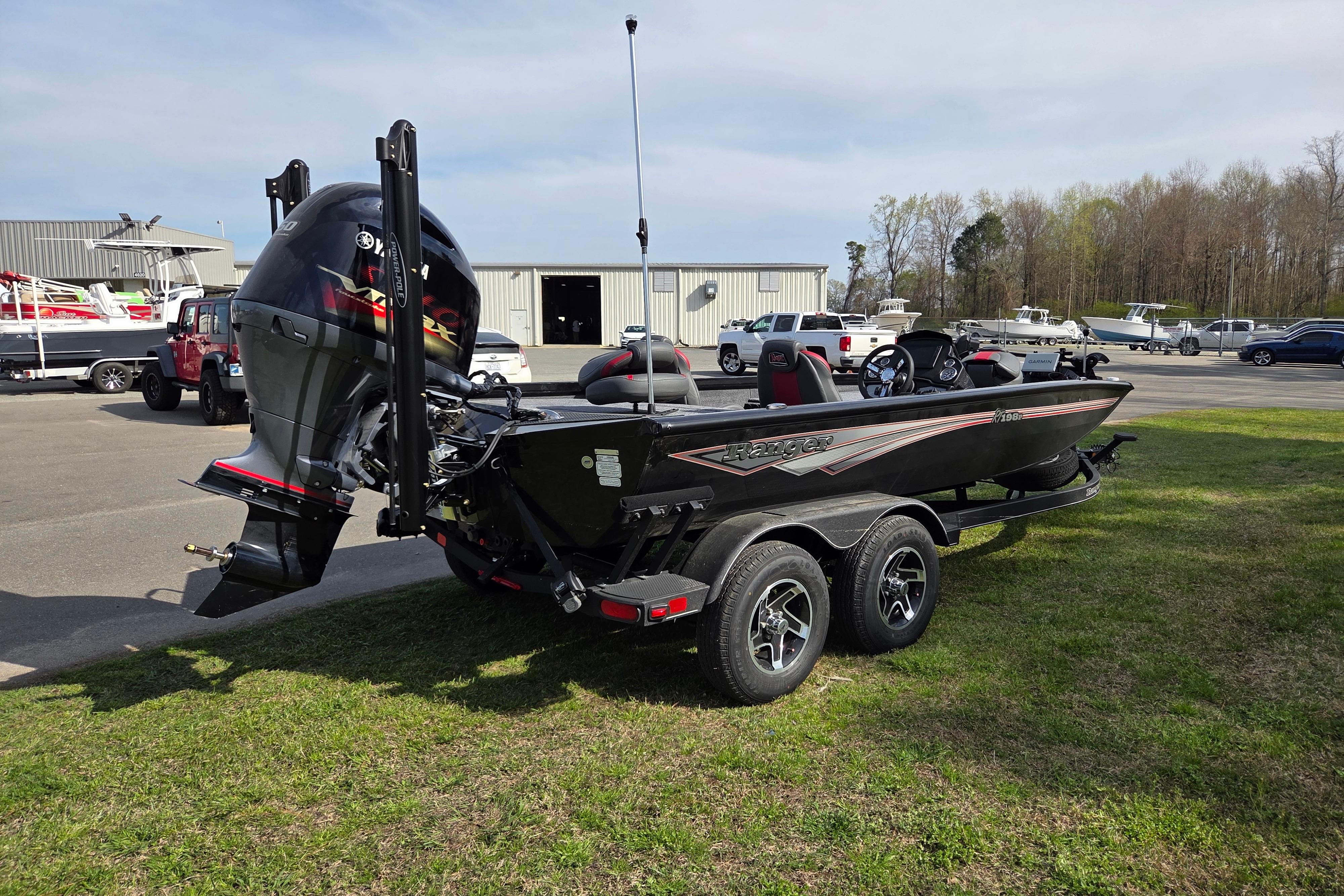 2026 Ranger RT198P boat on trailer, parking lot in background.
