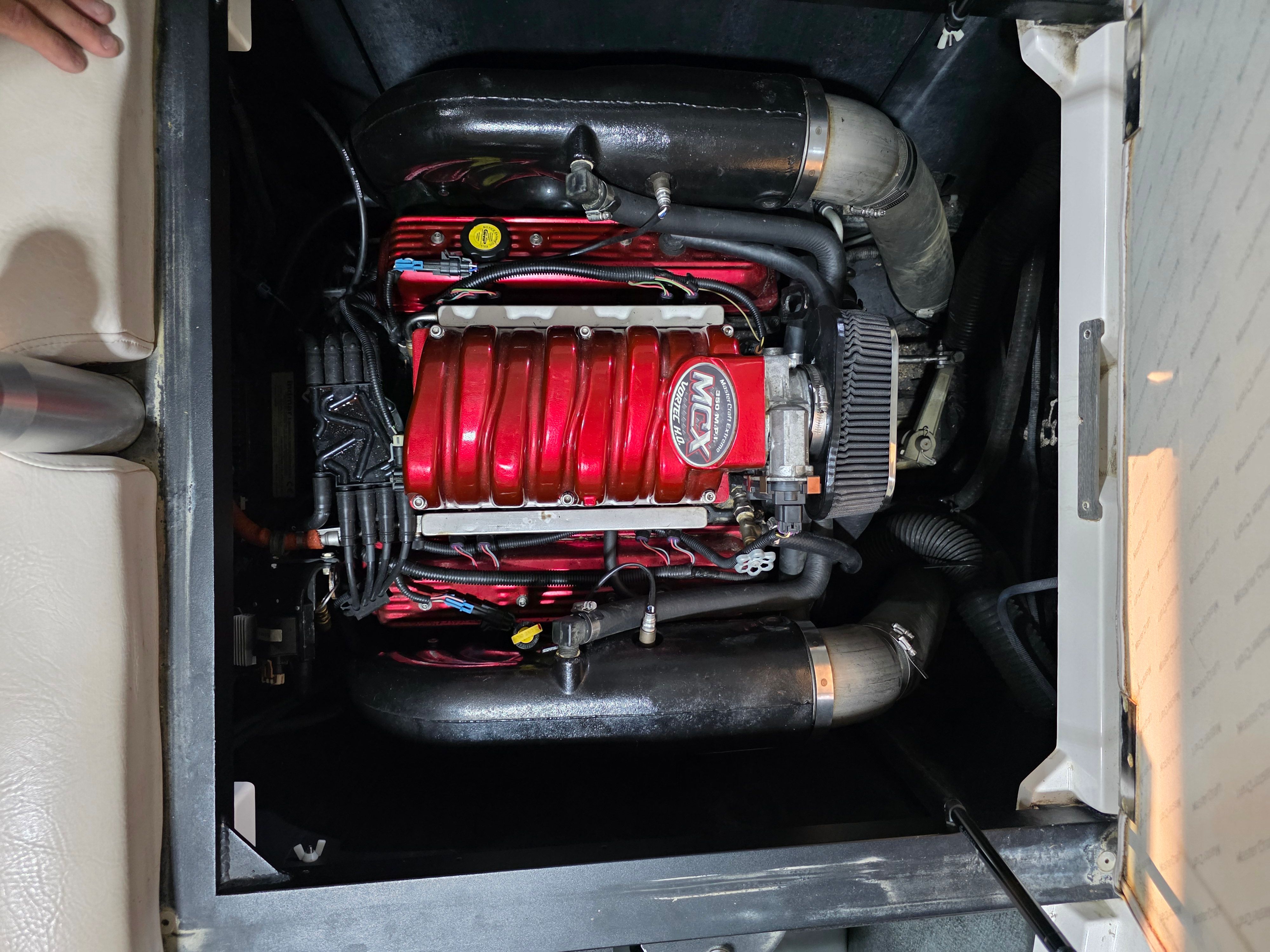 Engine compartment of a 2007 MasterCraft X-15 boat with red engine.
