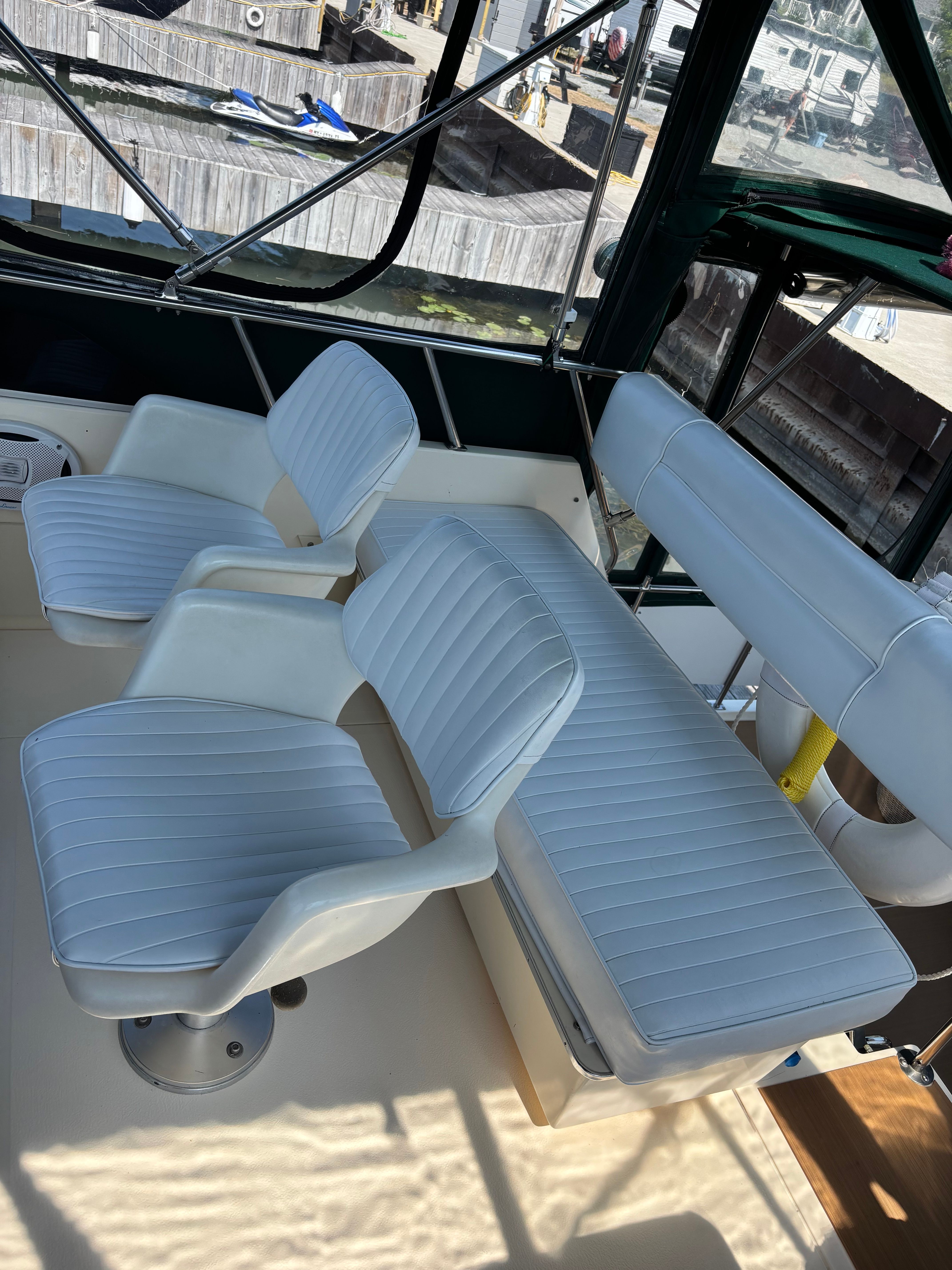 Interior of a 1986 Sea Ray 360 Aft Cabin yacht with white seating.