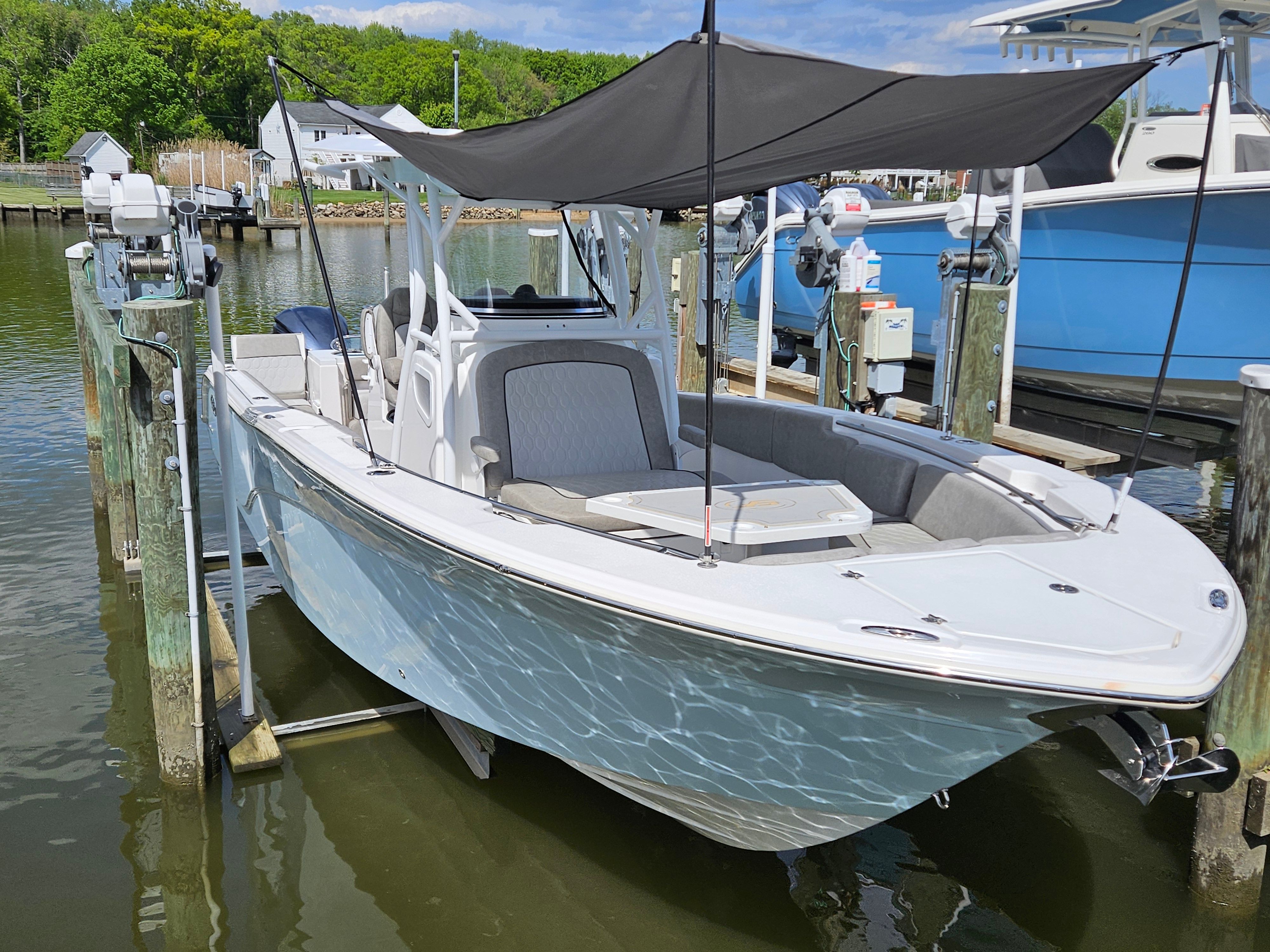 2021 Sea Fox 288 Commander boat docked with sunshade.