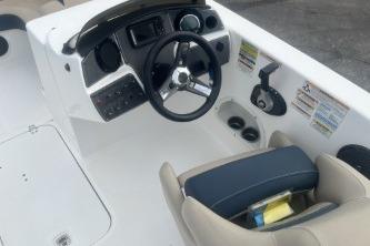 2021 Hurricane SunDeck Sport 192 RL OB boat cockpit with steering wheel and seating.