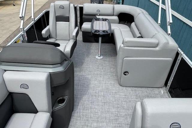 2026 Sun Tracker Party Barge 20 DLX interior with gray seating and table.