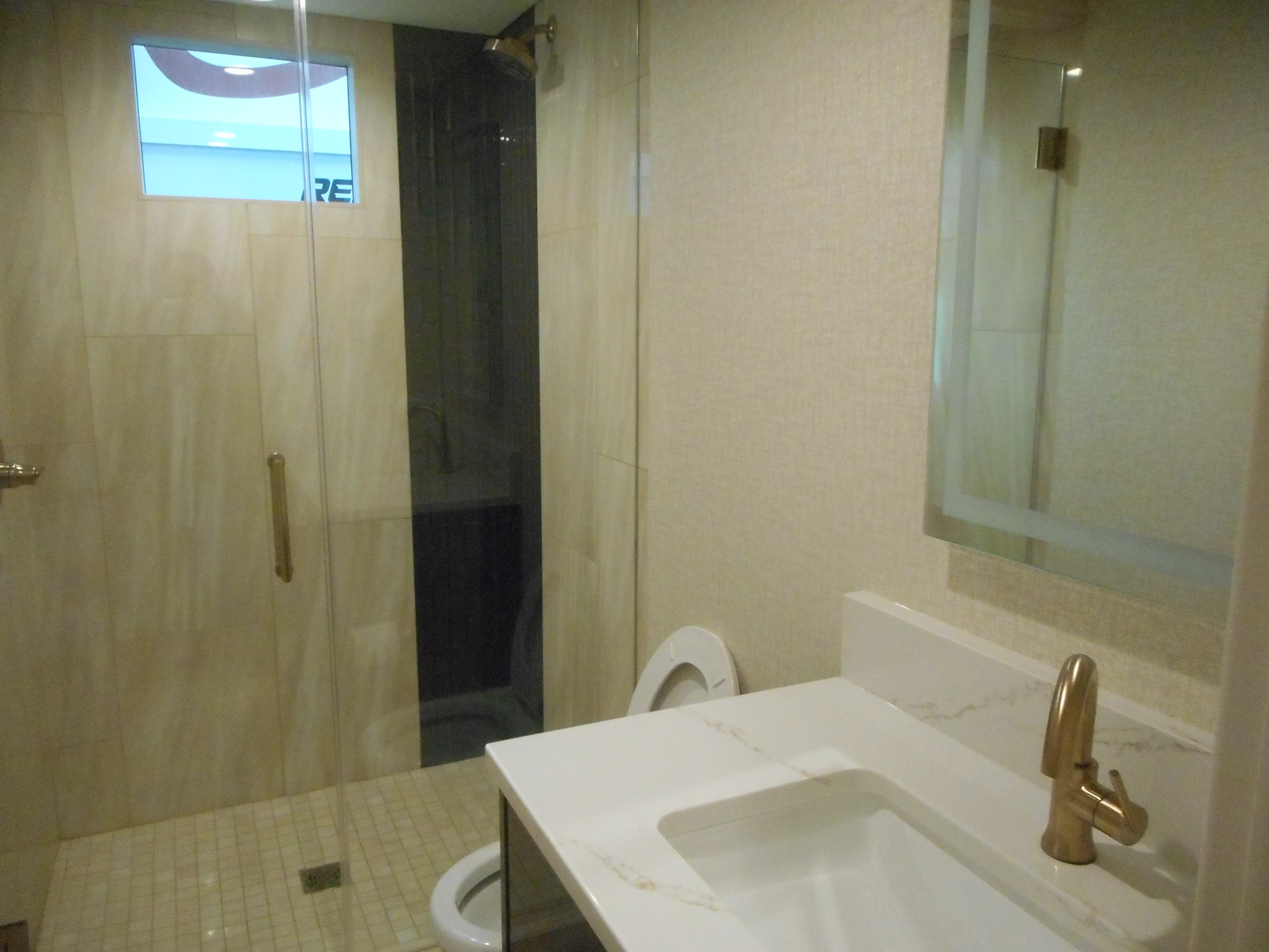 Modern bathroom with glass shower and marble sink, Adonia Sojourn Trip #9, 2021.