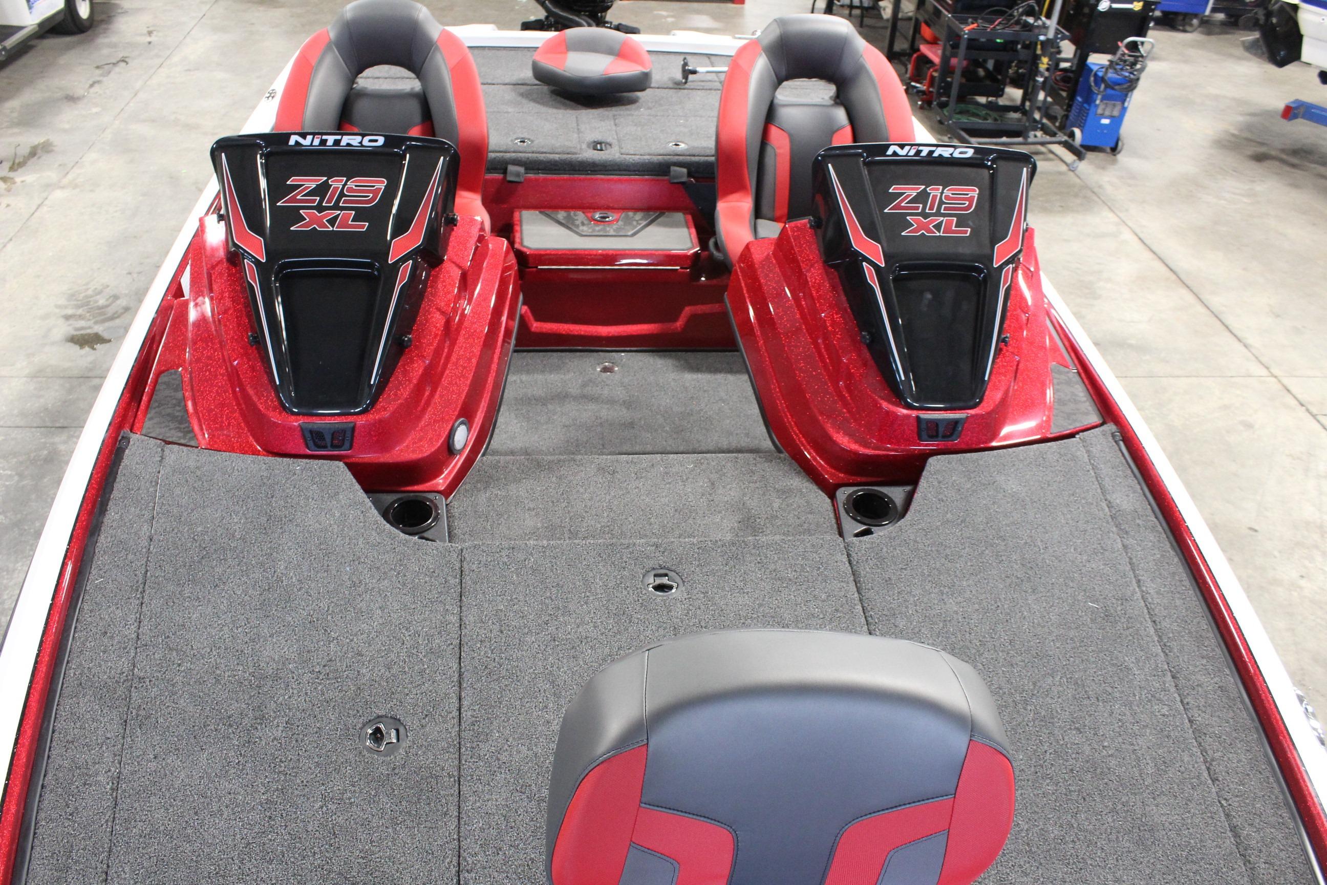 2026 Nitro Z19 XL Pro boat interior with red and black seating and carpeted deck.