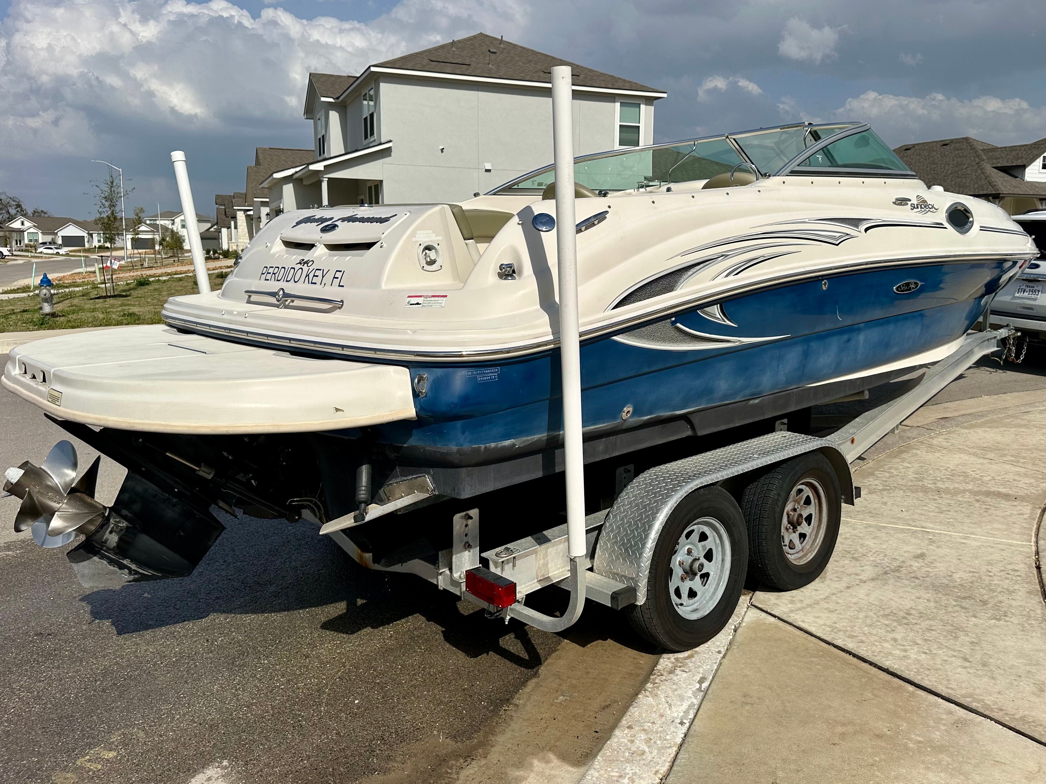 2006 Sea Ray 240 Sundeck on trailer in residential area.