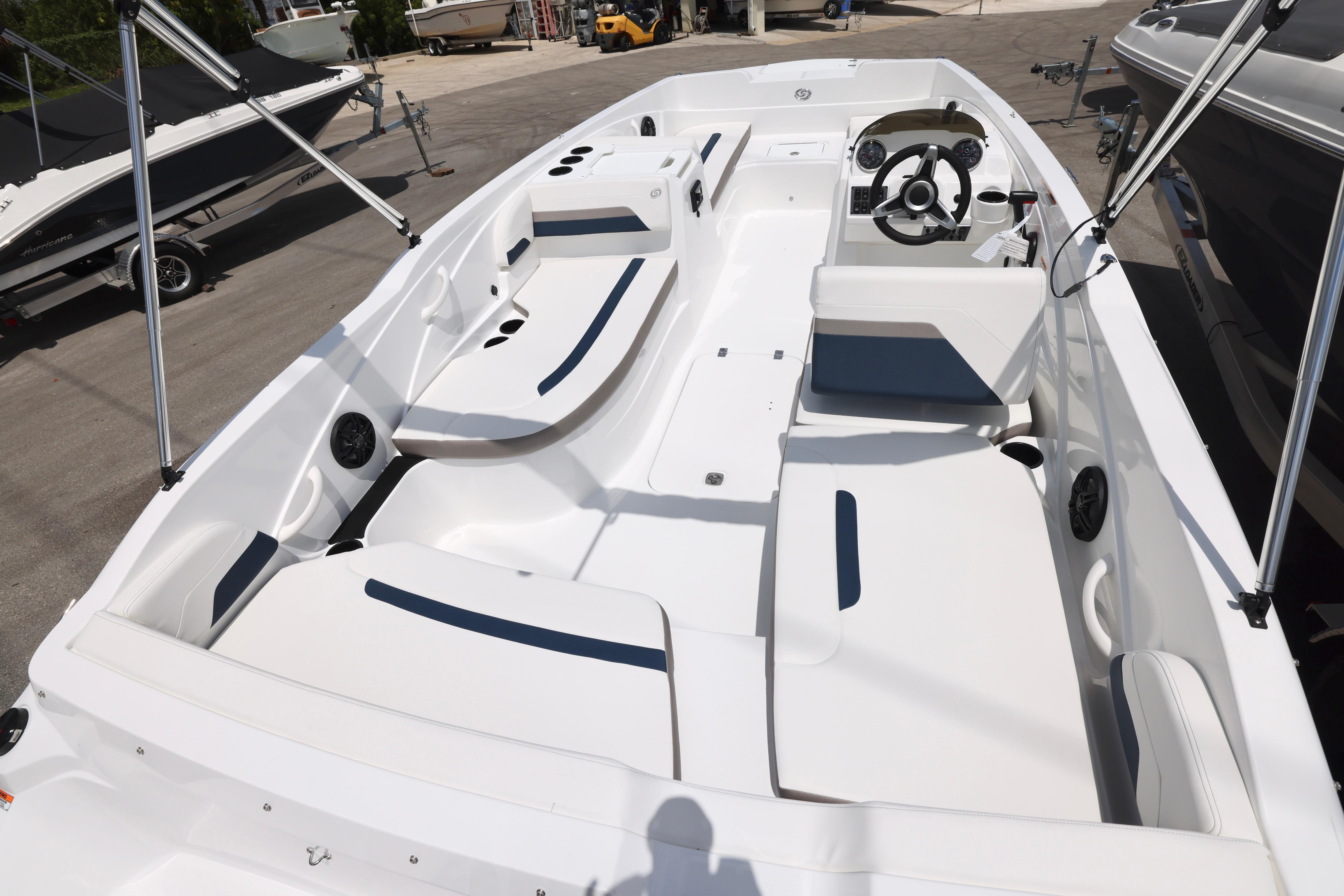 2026 Hurricane SunDeck Sport 205 OB boat interior with seating and steering console.