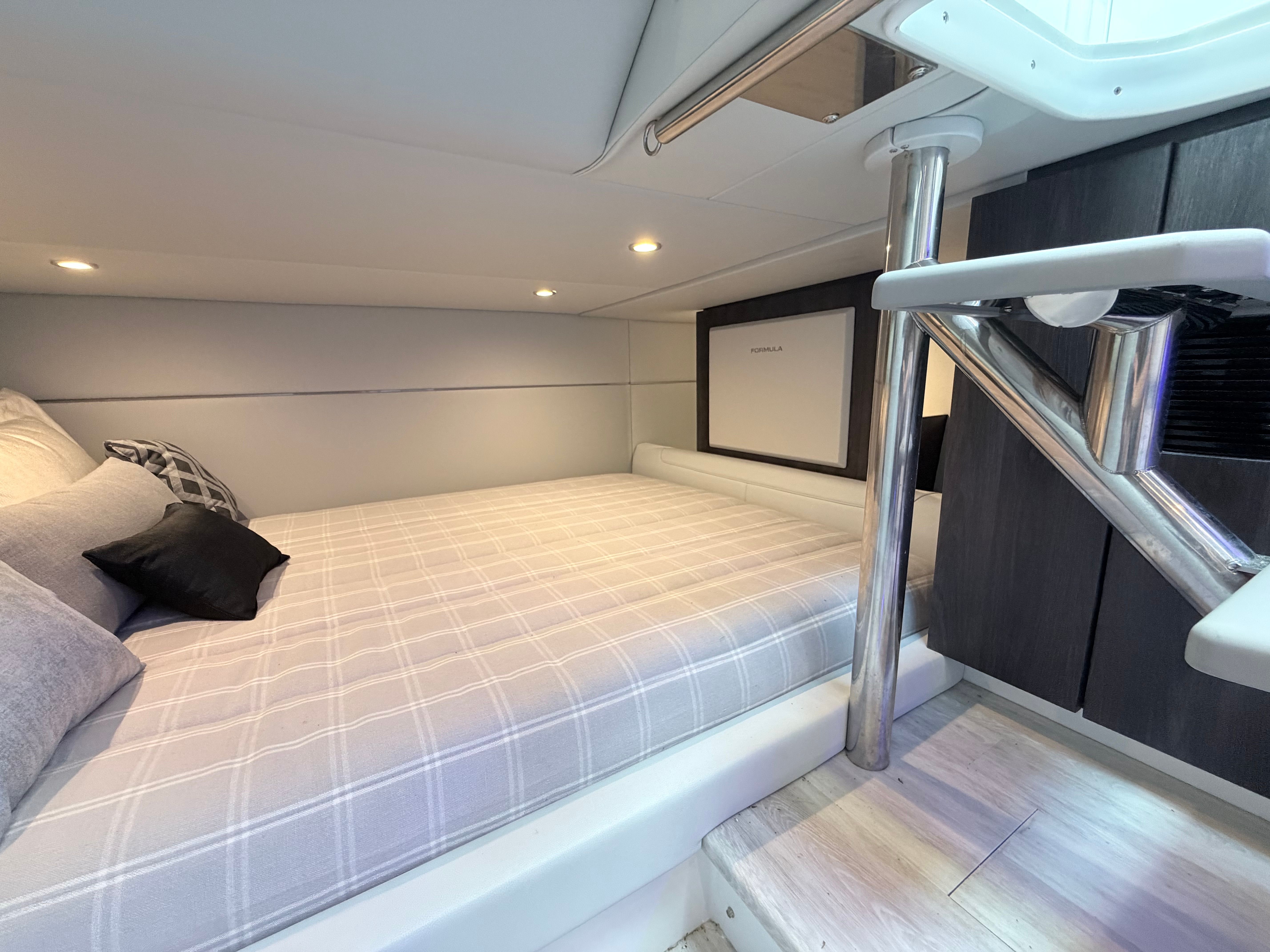 The image shows a cozy cabin with a large bed and modern decor details.