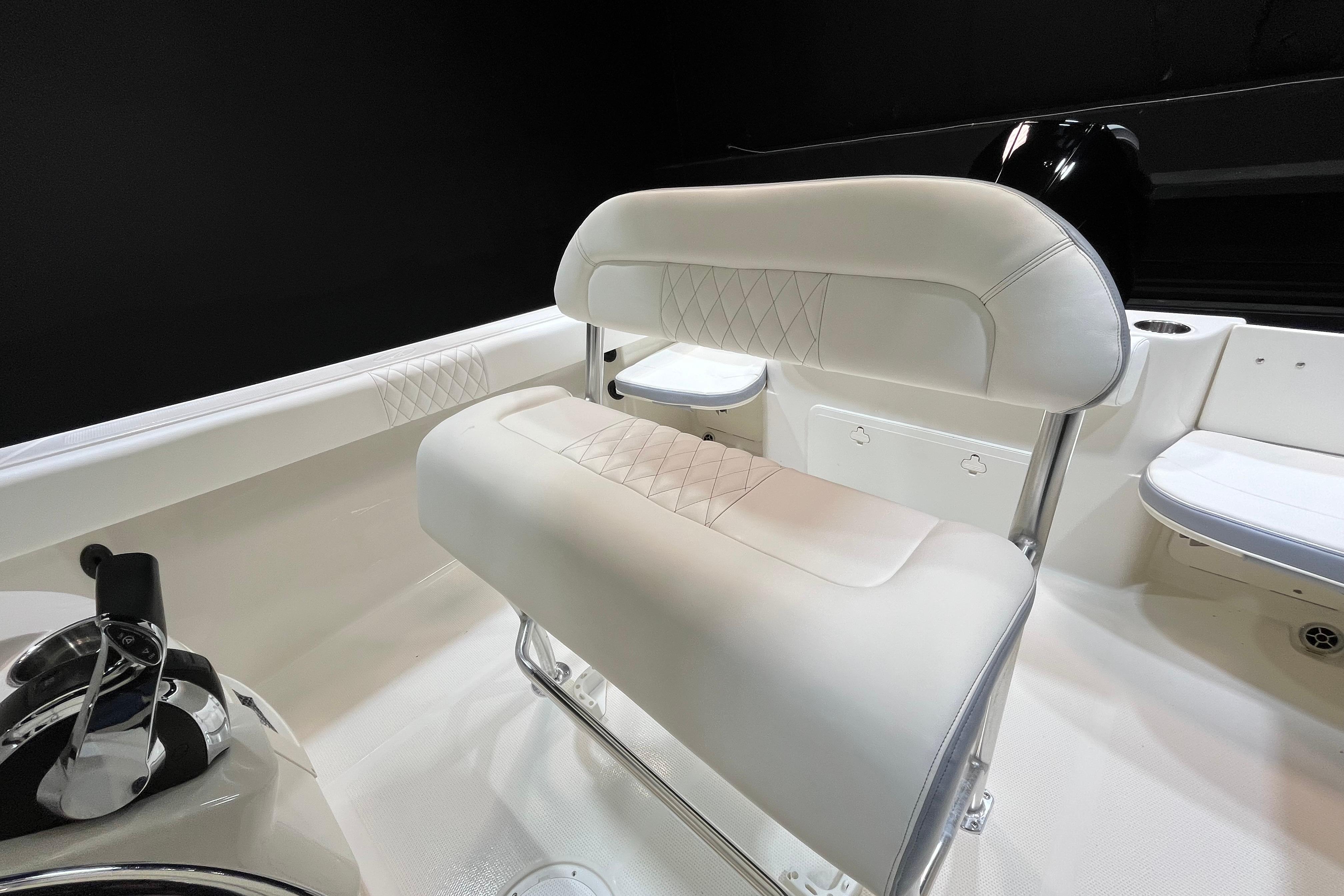 2022 Sailfish 242 CC boat interior with white cushioned seating and sleek design.