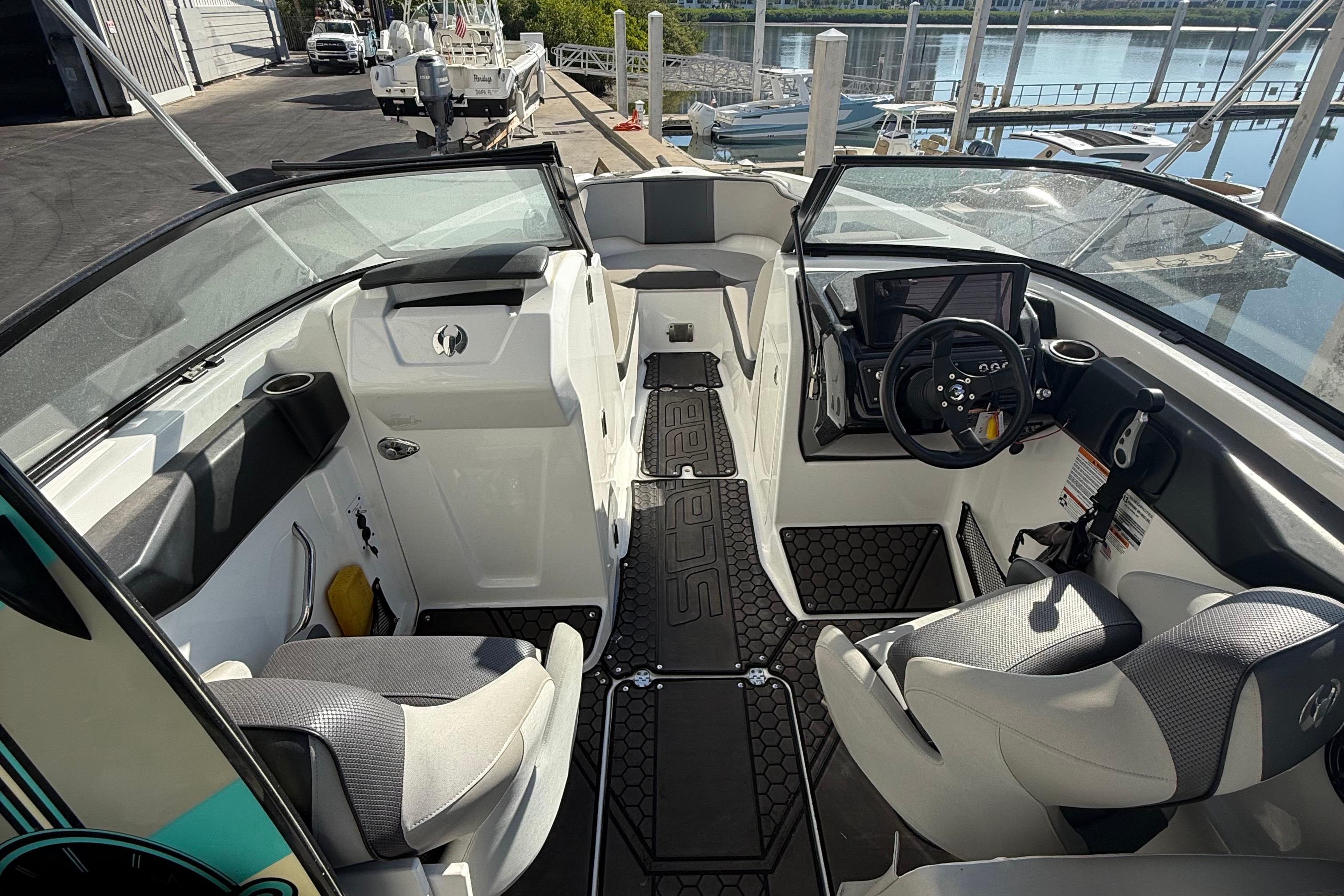 Interior of a 2021 Scarab 255 ID boat, featuring modern seating and controls.