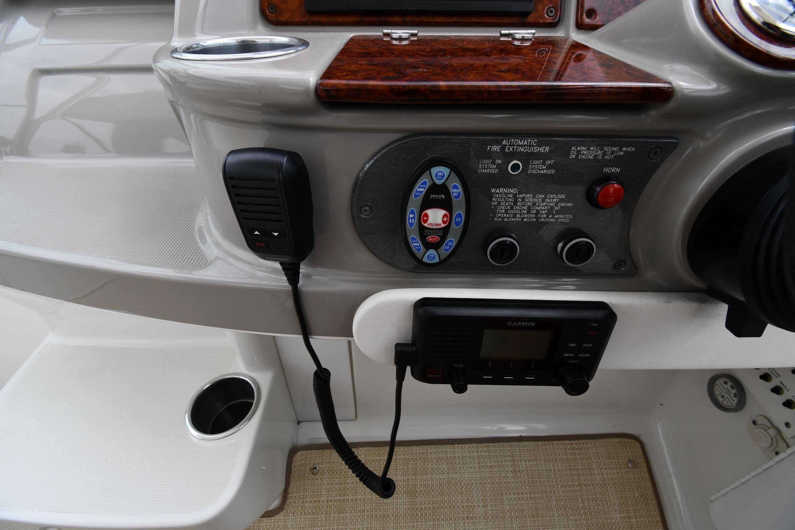2004 Formula 330 Sun Sport dashboard with controls, microphone, and Garmin device.