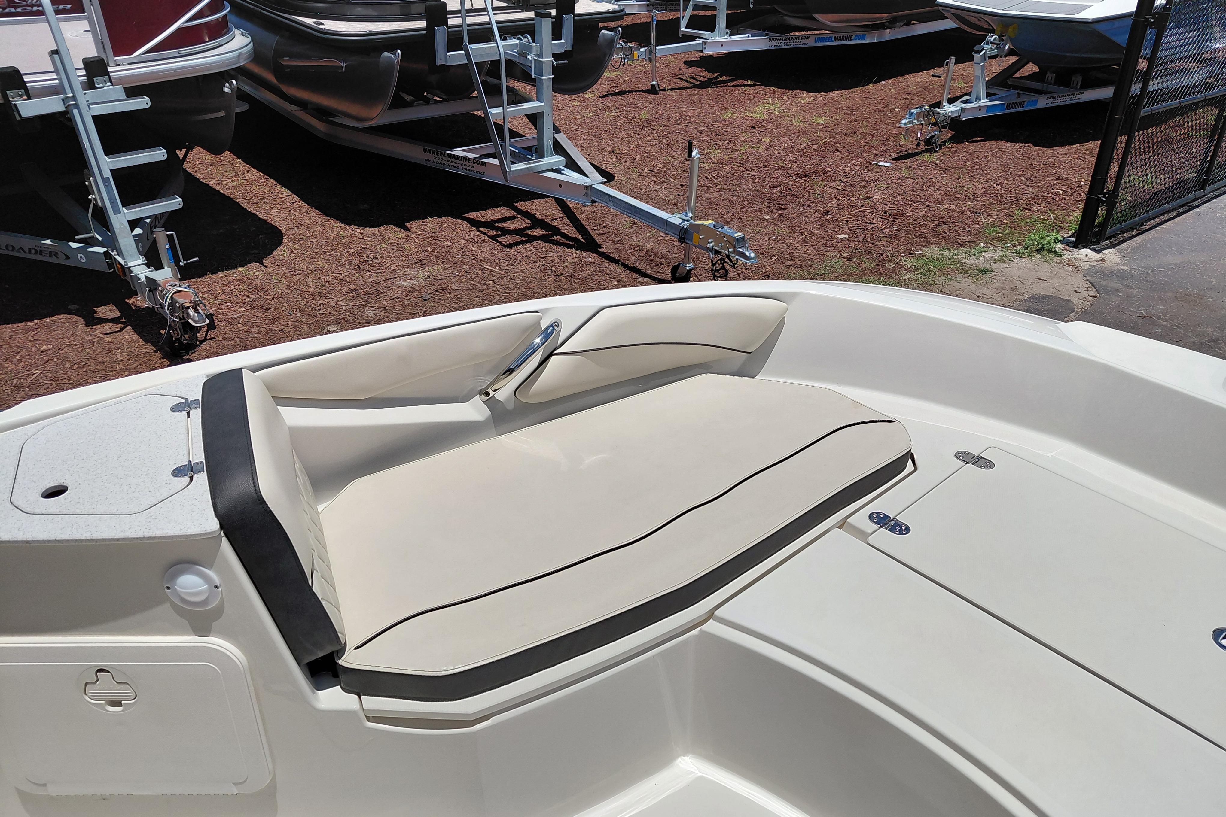 2023 Stingray 206 CC boat interior with beige seating and storage compartments.
