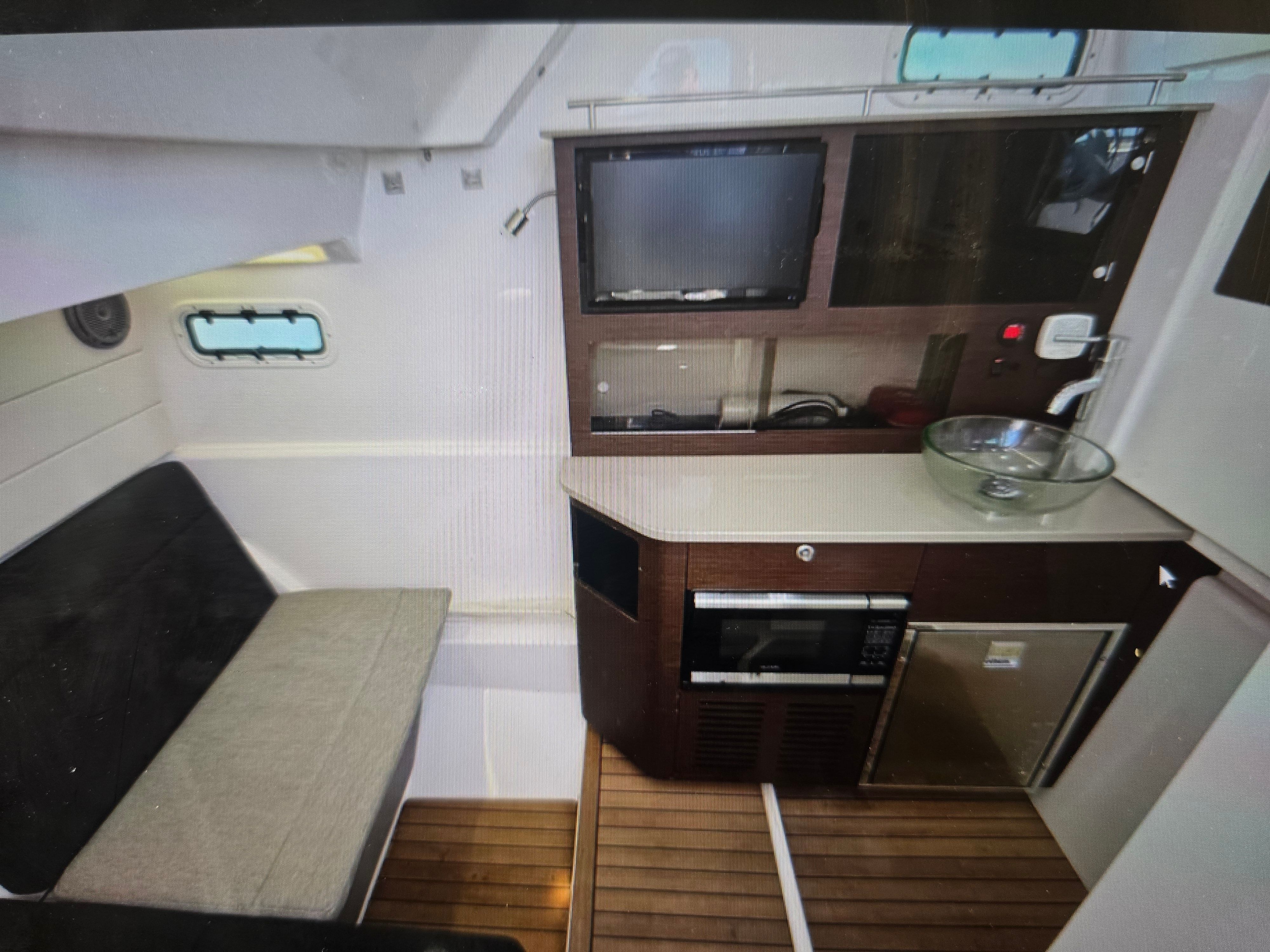 Interior of 2019 Everglades 435 Center Console with kitchenette.
