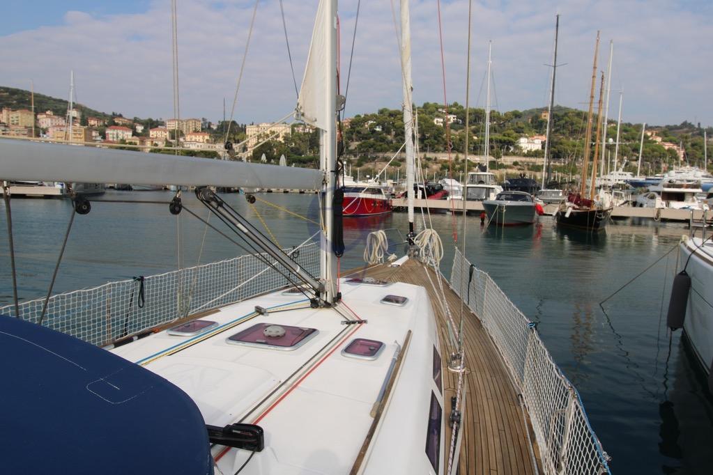 2009 Dufour 425 Grand Large sailboat docked in a scenic marina.