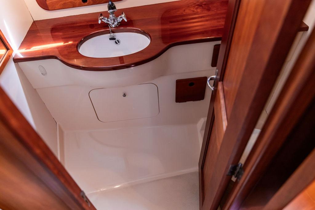 Hinckley Picnic Boat 36 Classic 2000 bathroom with wooden vanity and sink.