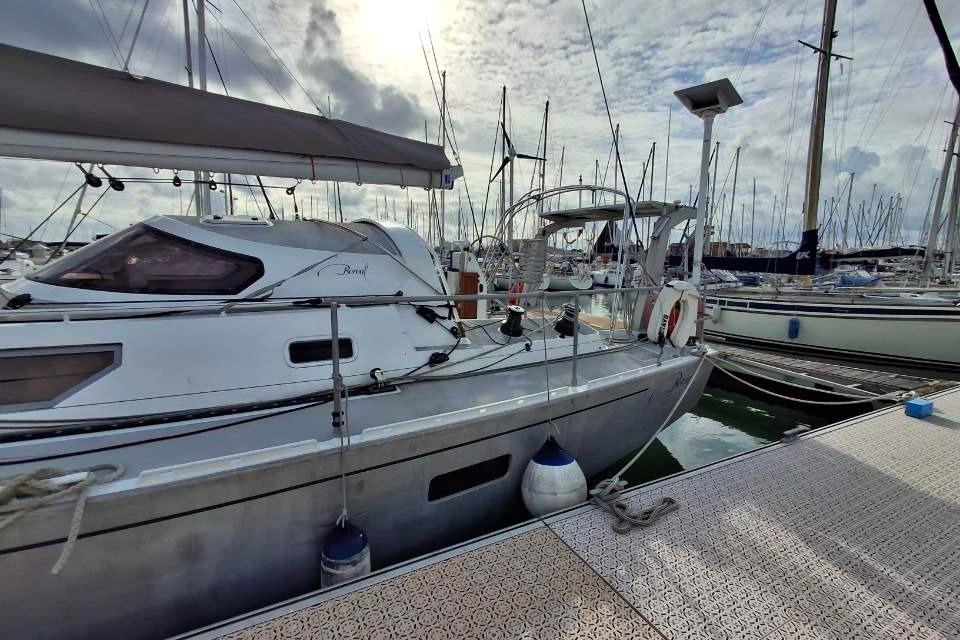 Sailboat Boreal 52, 2020 model, docked at marina under cloudy sky.