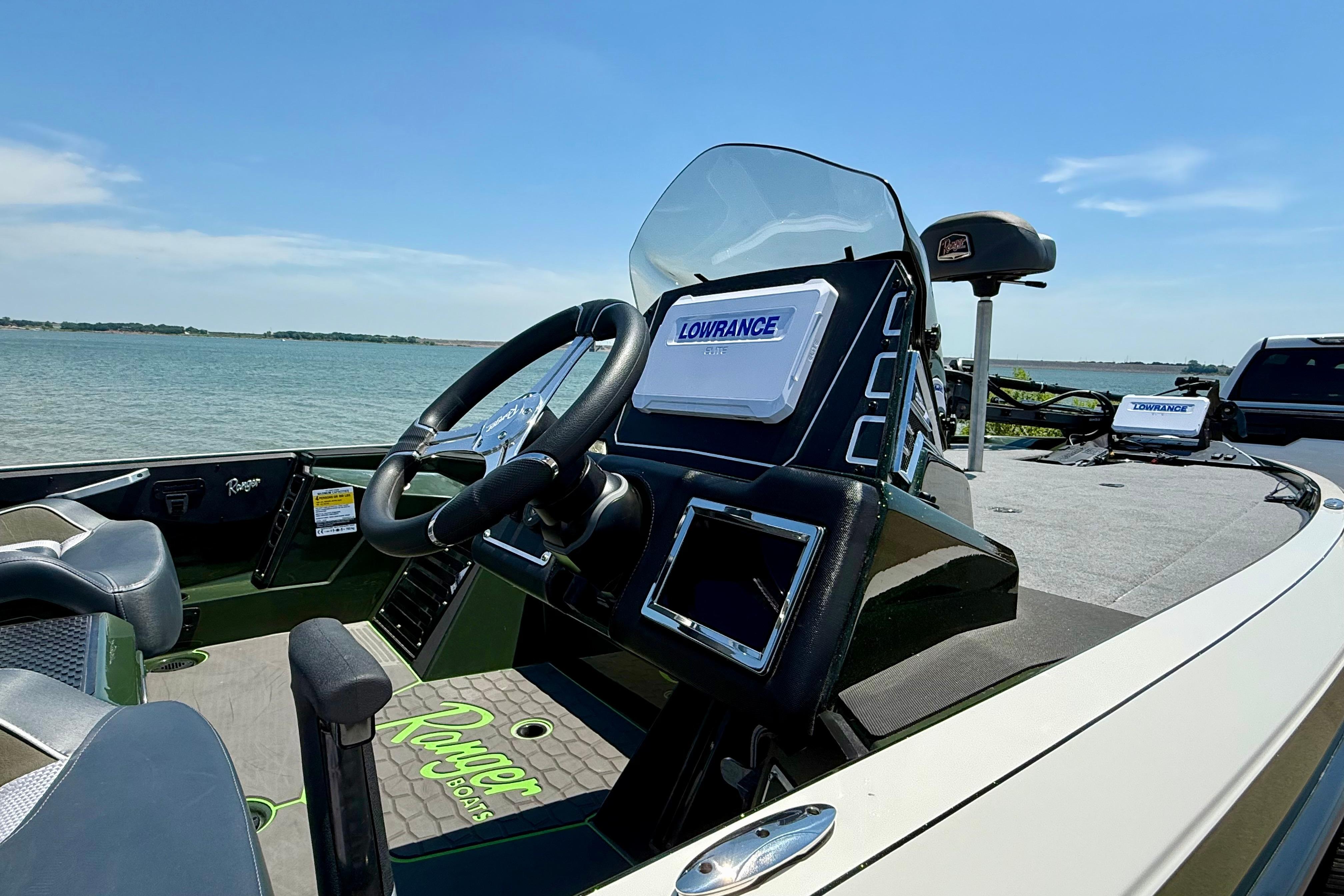 2026 Ranger Z519R boat interior with steering wheel and Lowrance electronics by the water.