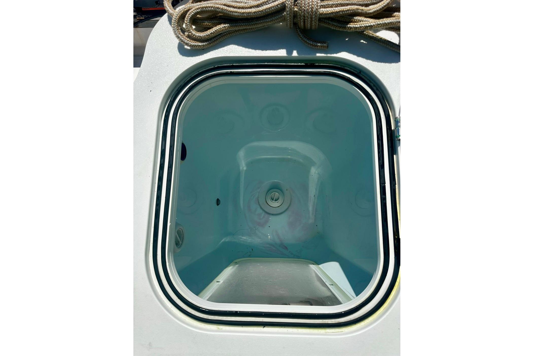Open hatch on 2002 Sea Fox 228 Commander boat, showcasing interior compartment.