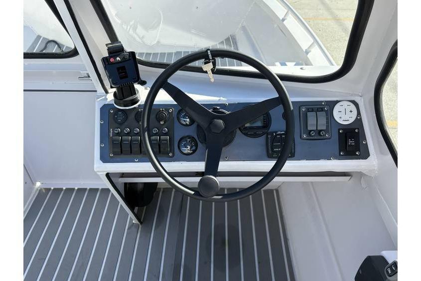 Steering console of a 1997 Scully's 18 WT boat with gauges and controls.