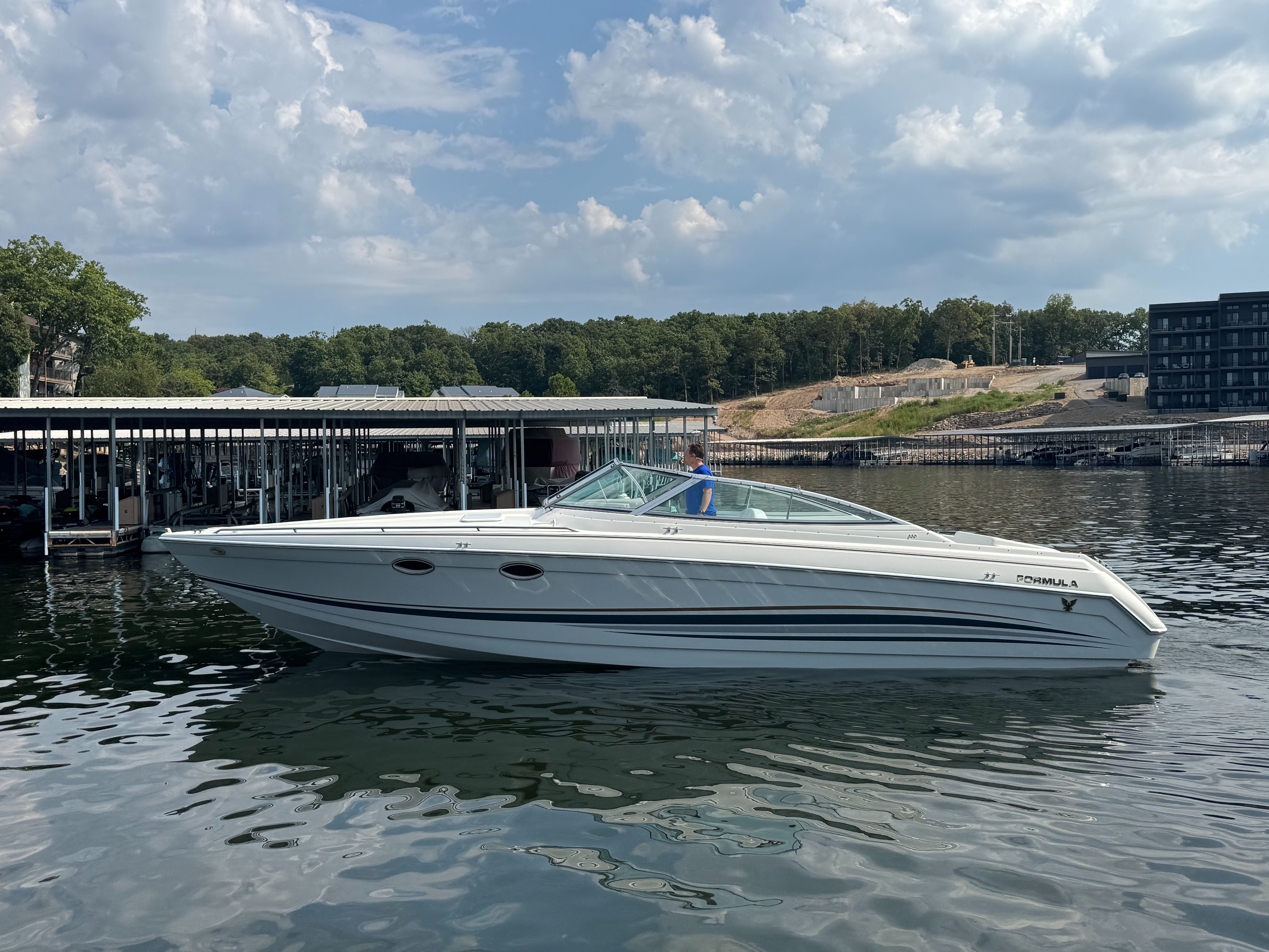2001 Formula 330 Sun Sport boat on calm water.