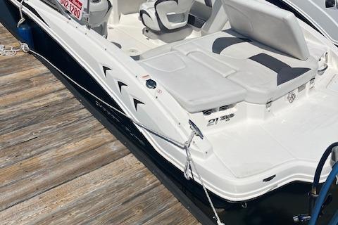 2015 Chaparral 21 H2O Sport boat docked, featuring sleek white design and comfortable seating.